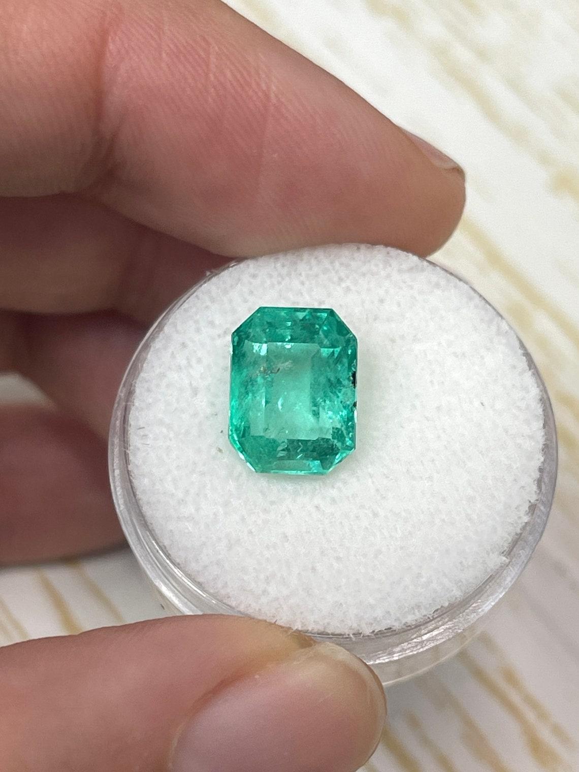 Stone: Emerald
Weight: 4.29-carats
Shape: Emerald Cut
Clarity: Transparent (Carbon Freckles on Girdle/Edge)
Luster: Very Good
Color: Medium Green
Measurements: 10.82mm x 8.30mm x 7.02mm
Geographic Origin: Colombia
Treatment: Natural, Oiling

Notes: