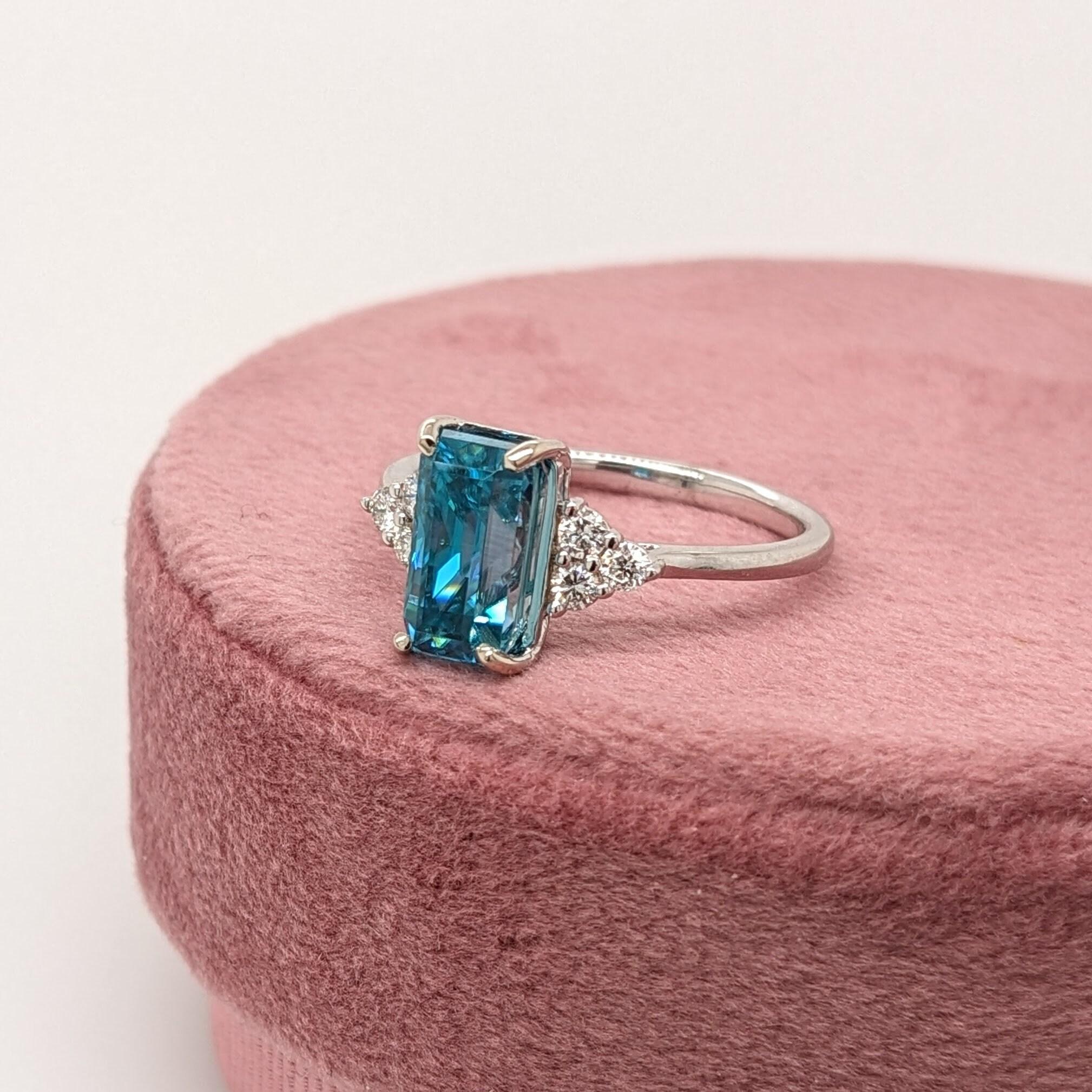 This statement ring features a gorgeous sparkling natural blue zircon in 14K solid white gold with a trio of diamond accents on either side making a cute minimalist design. A gorgeous ring for a modern bride, a December baby, or a lover of things