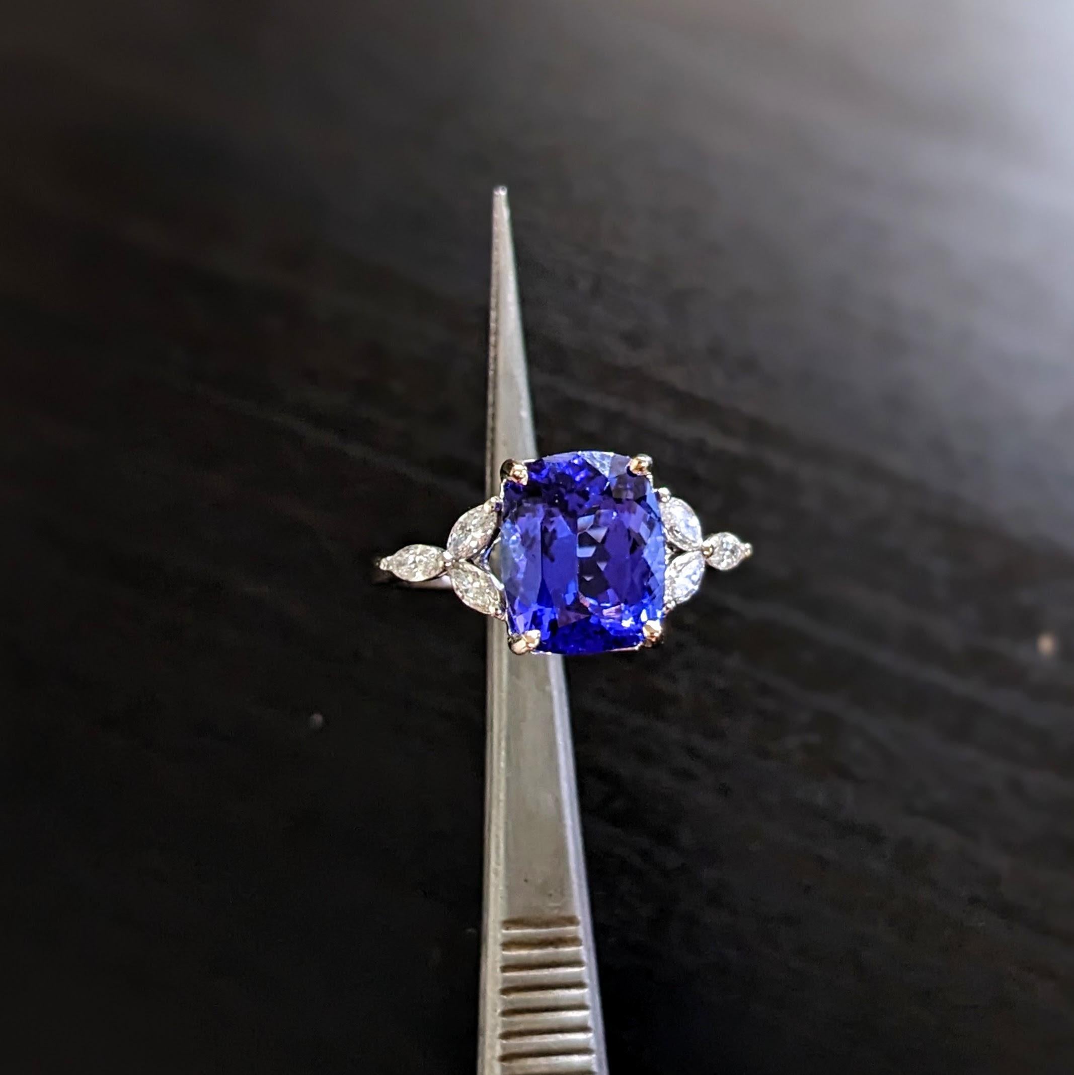 This statement ring features a 4.28 carat cushion cut Tanzanite gemstone with natural earth mined diamonds set in solid 14K gold. This Tanzanite ring makes a beautiful December birthstone gift for your loved ones! 

Specifications

Item Type: