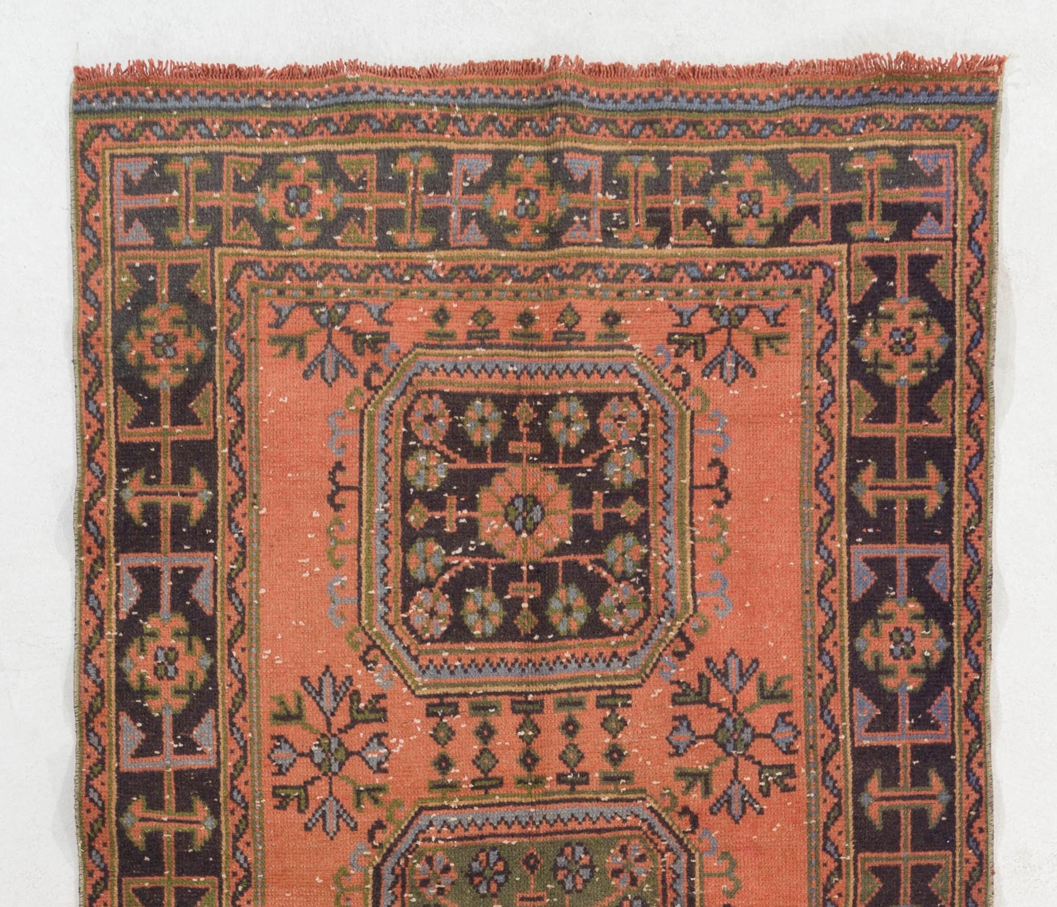 A vintage Turkish runner rug. Hand-knotted in Turkey in 1960s and multiple geometric medallion design. The rug is in good condition, sturdy and clean as a brand new rug. It can be used in a high traffic area and suitable for both residential and