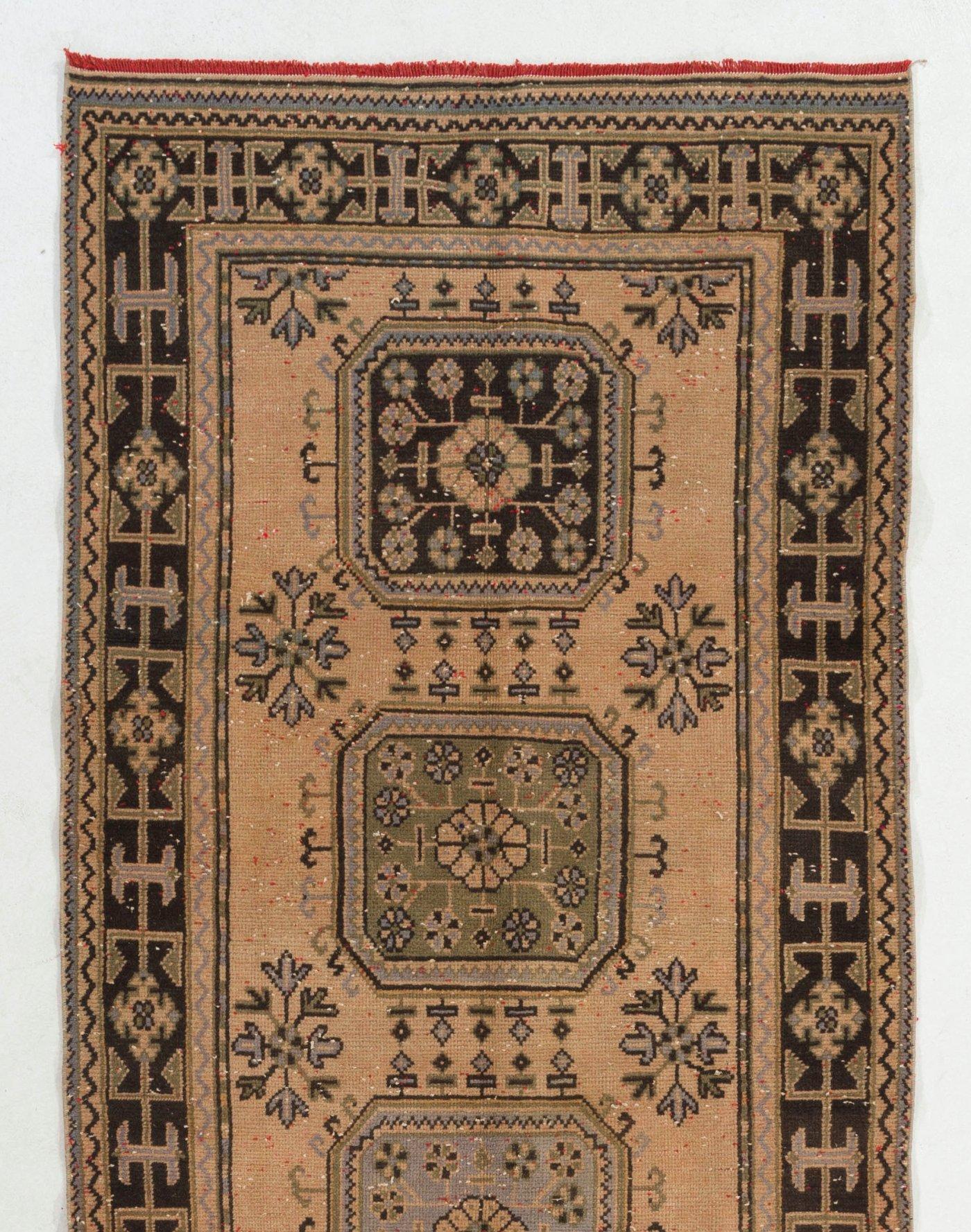 A gorgeous vintage Turkish runner rug for hallway decor. It was hand-knotted in the 1960s with low wool on cotton foundation and features a multiple medallion design. It is in very good condition, professionally-washed, sturdy and suitable for areas