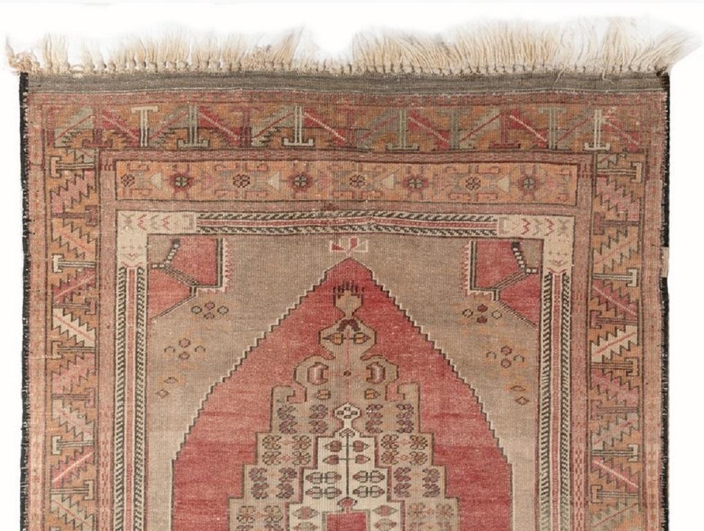 A finely hand-knotted vintage Turkish carpet from 1960s featuring a geometric medallion design. The rug is made of medium wool pile on wool foundation. It is heavy and lays flat on the floor, in very good condition with no issues. It has been washed