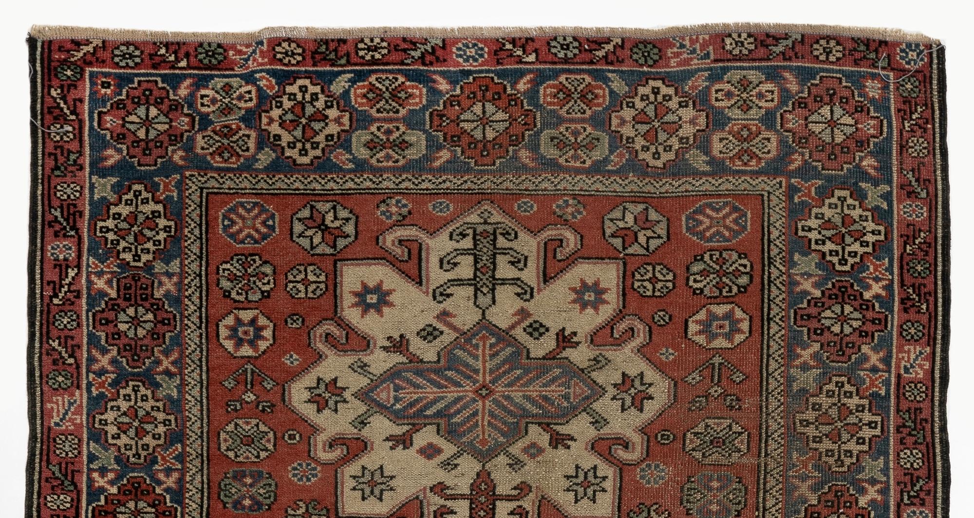 A one-of-a-kind vintage Turkish rug that is very finely hand-knotted with low wool pile on wool foundation made in the 19. It has a beautifully detailed and well-drawn design of three large geometric medallions running across its length and a