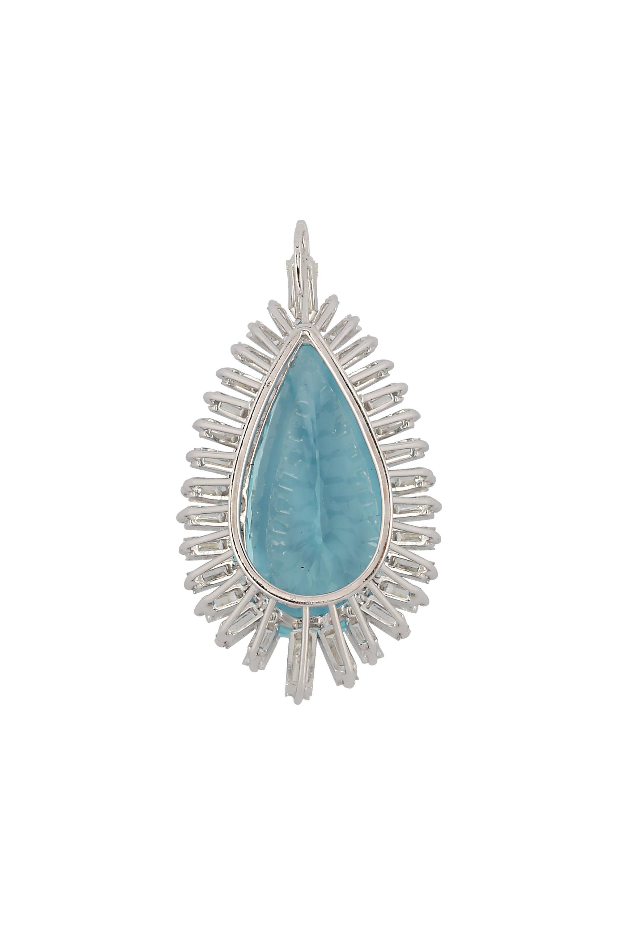 This engaging and distinctive pendant features a bright blue pear shaped aquamarine, weighing approximately 43 carats, beautifully framed by a dramatic halo of graduated diamond baguettes. Fabricated in 18- karat white gold. (Chain sold separately)

