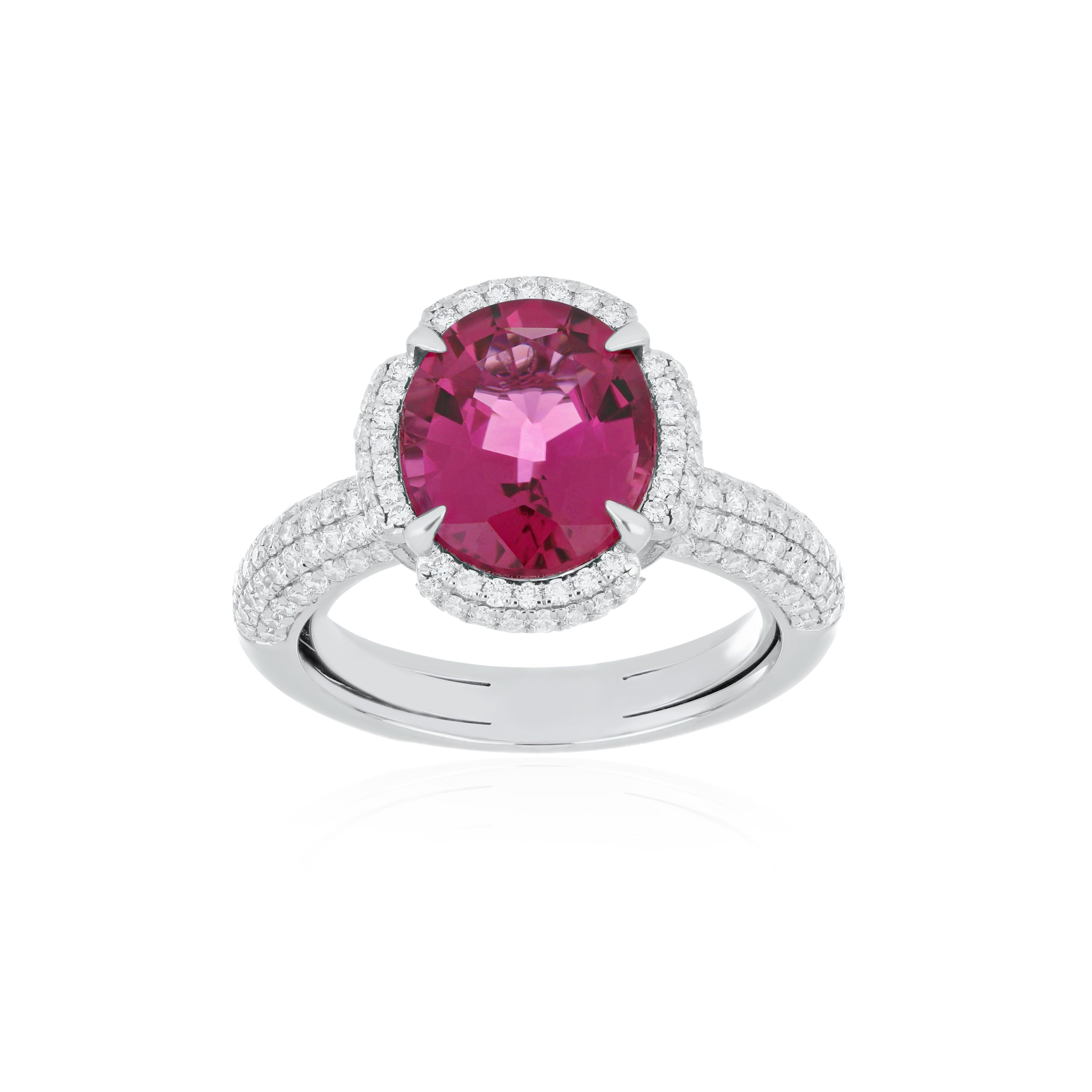 Elegant and exquisitely detailed 18K White Gold Ring, with 4.30Cts Oval Shape Rubellite set in center and Surrounded by Micro pave Diamonds, weighing approx. 1.05 CT's. total carat weight and Ring to further enhance the beauty of the ring.