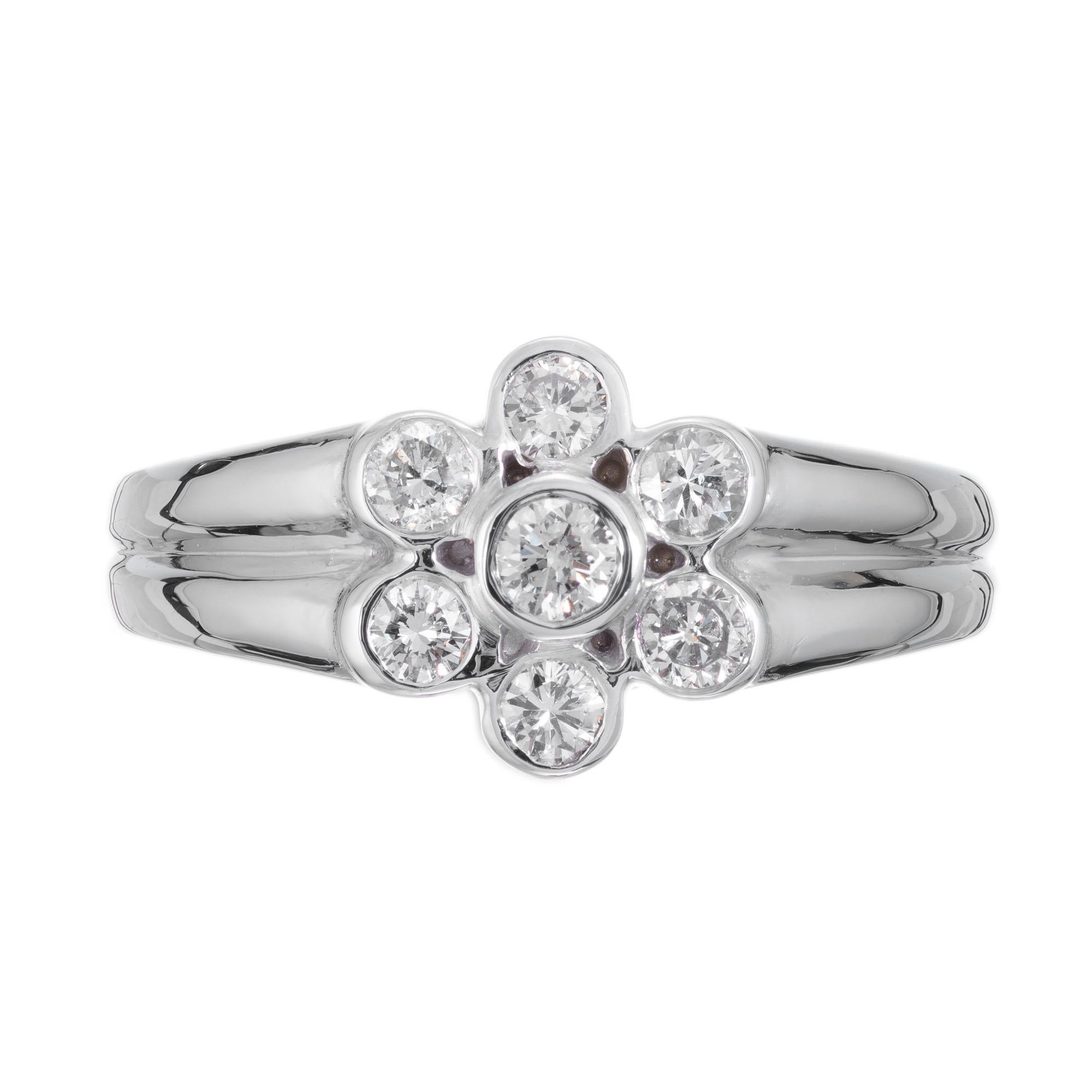 7 round diamond flower design ring. 14 white gold setting with .43ct diamonds. 

7 round brillaint cut diamonds. approx. total weight:.43ct J-K, VS-SI
Size: 6.75 and sizable
wide at top: 10.2
high at top: 4.9mm
wide at bottom: 3.3mm
tested: 14k