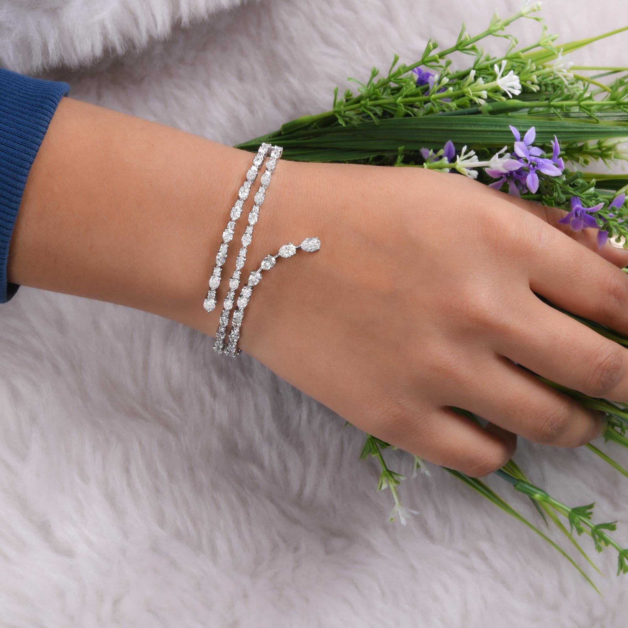 This 4.3 Carat SI/H Diamond Wide Bracelet 18 Karat White Gold features a bangle bracelet with a dramatic wrap. The design is characterized by multiple, articulated rows of diamonds that flow across the top of the wrist.
Diamonds are a universal