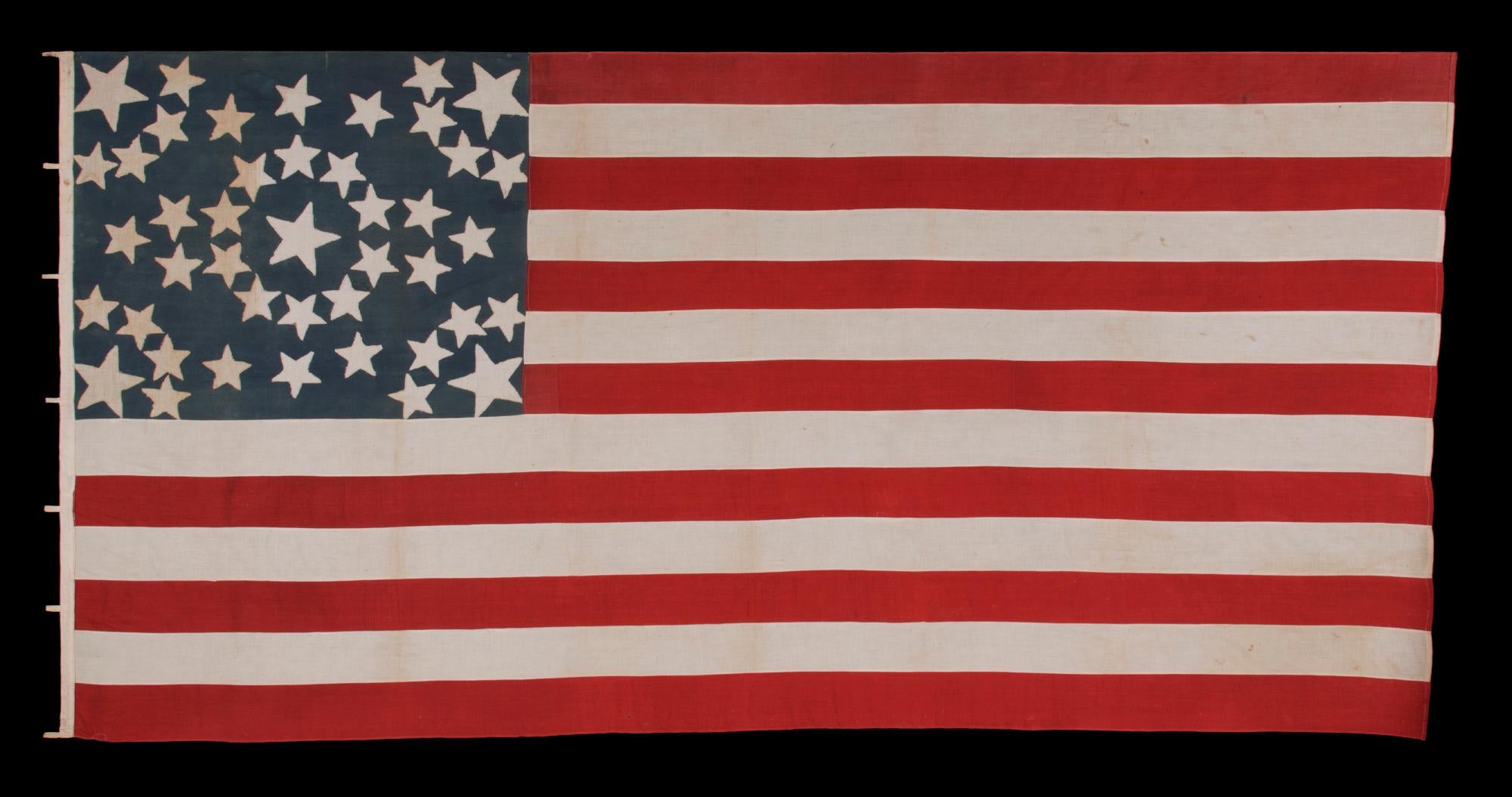 43 Star Antique American Flag Reflecting Idaho Statehood, One of the Rarest Star Counts Among Surviving American Flags of the 19th Century; A Masterpiece of Early Flag-making with an Exceptional Starburst Medallion Configuration, Circa