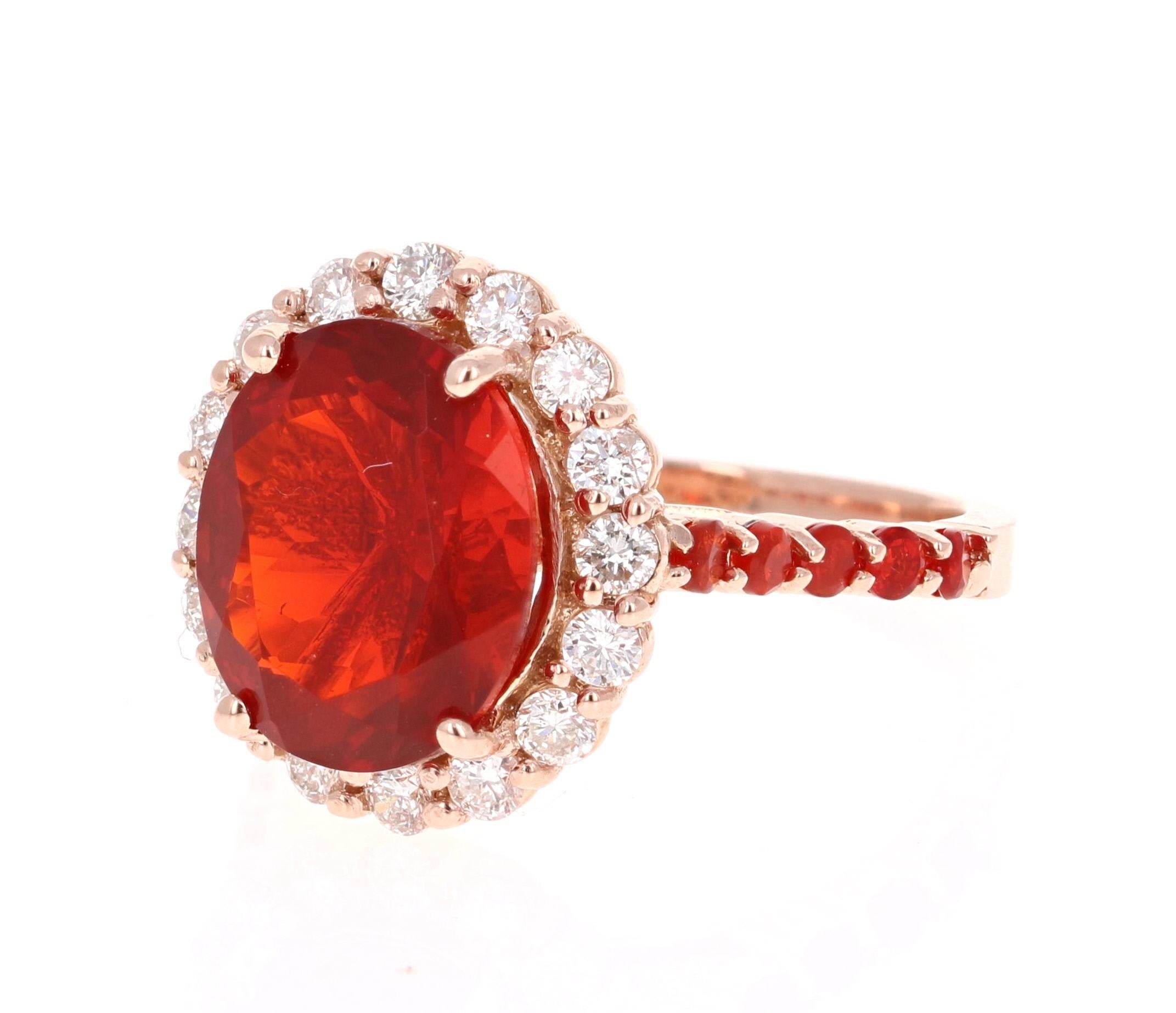 Beautiful Fire Opal and Diamond Ring. This ring has a 3.34 carat Oval Cut Fire Opal in the center of the ring and is surrounded by a halo of 18 Round Cut Diamonds that weigh a total of 0.68 carats and there are 10 Round Cut Fire Opals along the