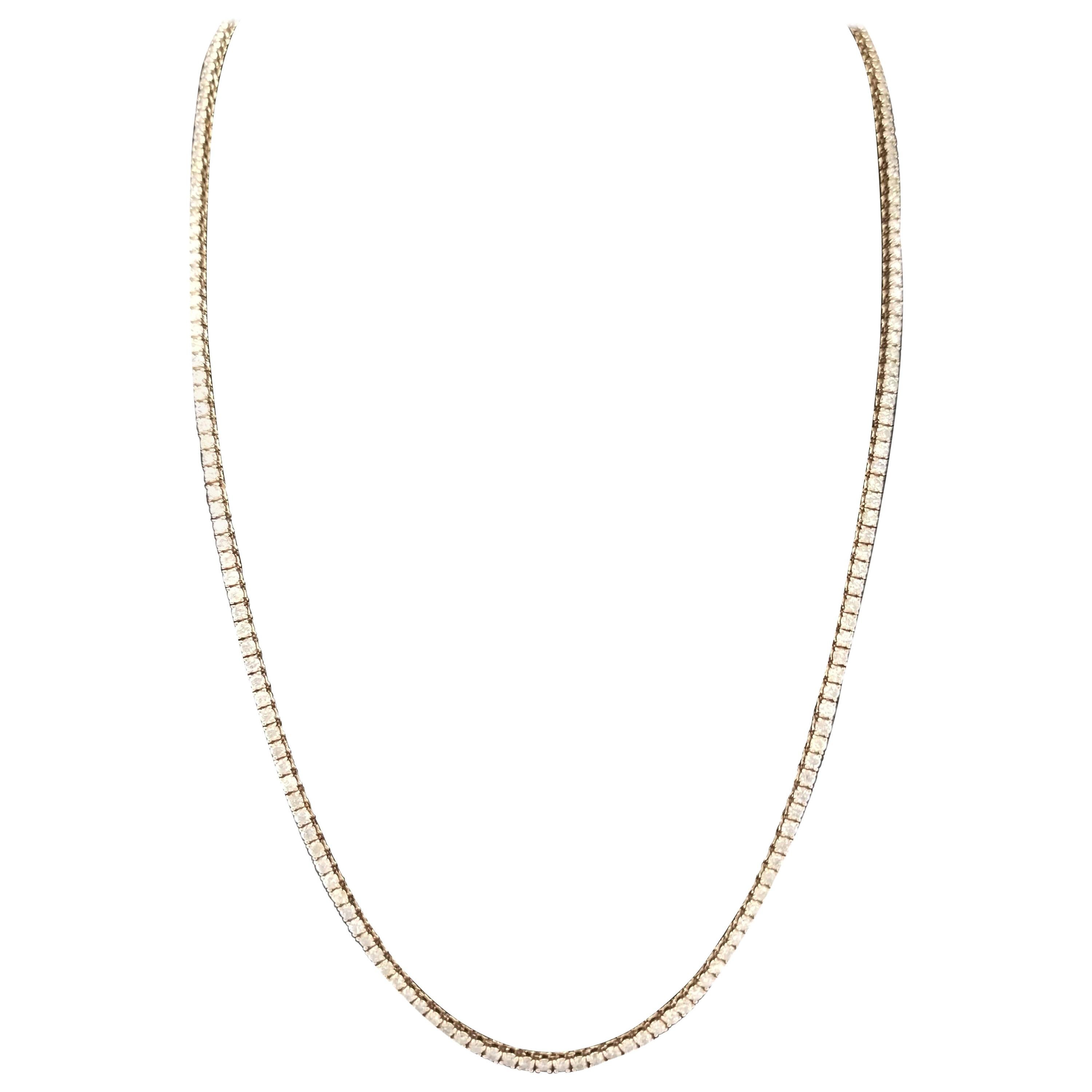 Elegantly simple 14 Karat Yellow Gold Round Brilliant Cut Diamond Tennis Necklace set on 4 prong setting. The total diamond weight is 4.30 carats. The closure is an insert clasp with safety clasp. Length is 18 inches. Average Color I, Clarity SI.