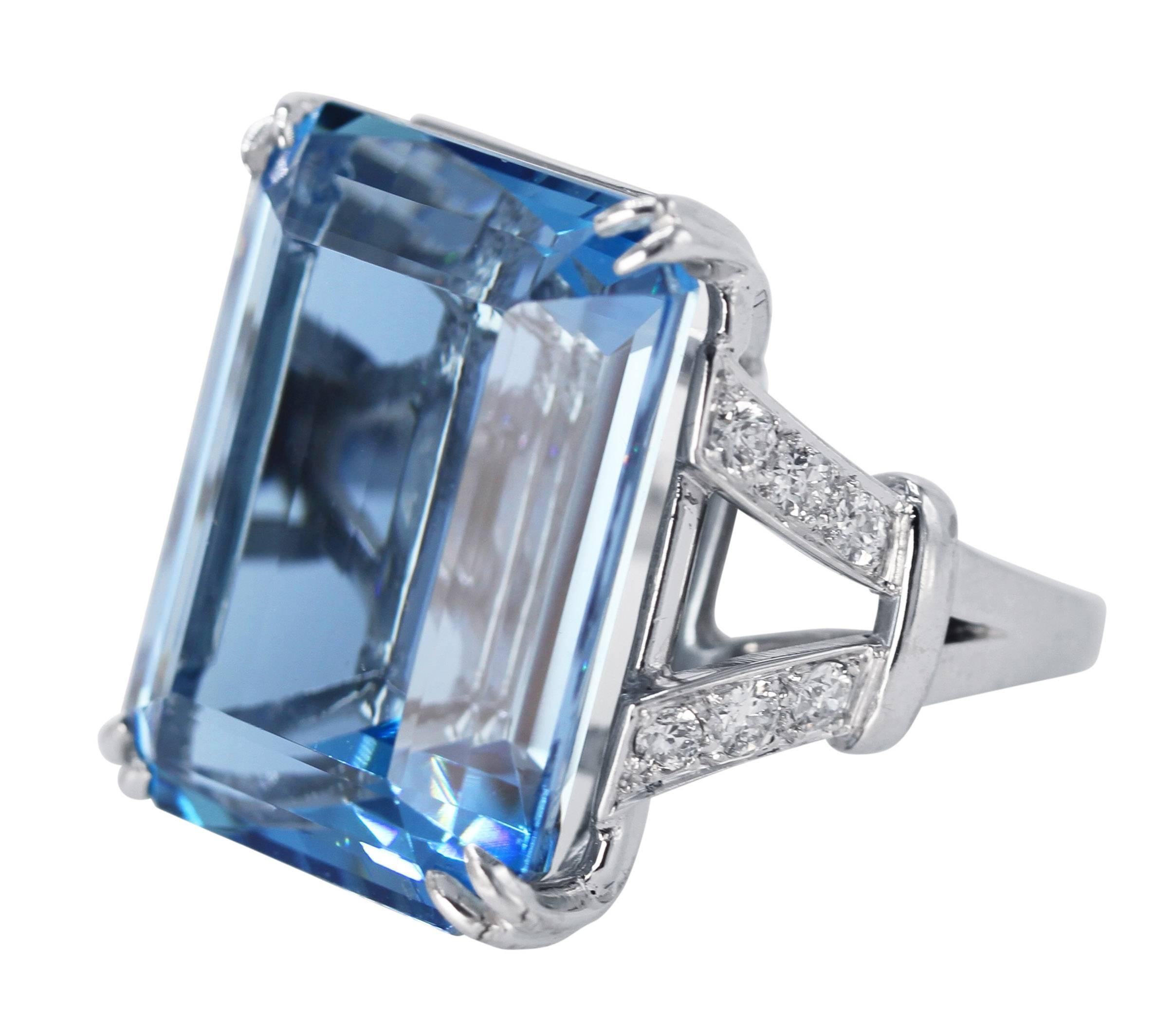 18 Karat White Gold, Aquamarine and Diamond Ring
• Step-cut aquamarine weighing 43.08 carats
• 12 round diamonds approximately 0.75 carat
• measuring 1 by 3/4 inch, gross weight 20.8 grams, size 7