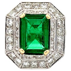 4.31 Carat Emerald 3.48 Carat Round Diamond Platinum 18K Gold Halo Ring