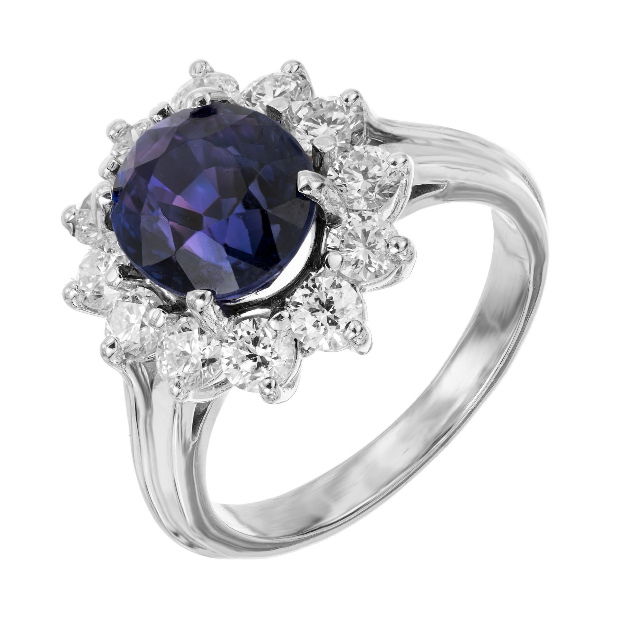 Vintage 1950's sapphire and diamond ring. Sensational 4.31ct oval center color change sapphire mounted in a handmade 14k white gold wire setting. A halo of 12 round ideal cut diamonds totaling 1.20cts complete this engagement ring. The diamonds have