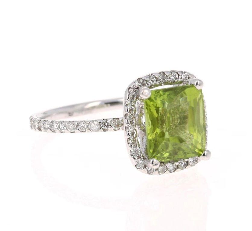 Bright, Beautiful and Bling! 

This ring has a 3.77 Carat Square-Emerald Cut Peridot and has 54 Round Cut Diamonds that weigh 0.54 Carats. The total carat weight of the ring is 4.31 Carats. 

It is set in 14 Karat White Gold and weighs approximate