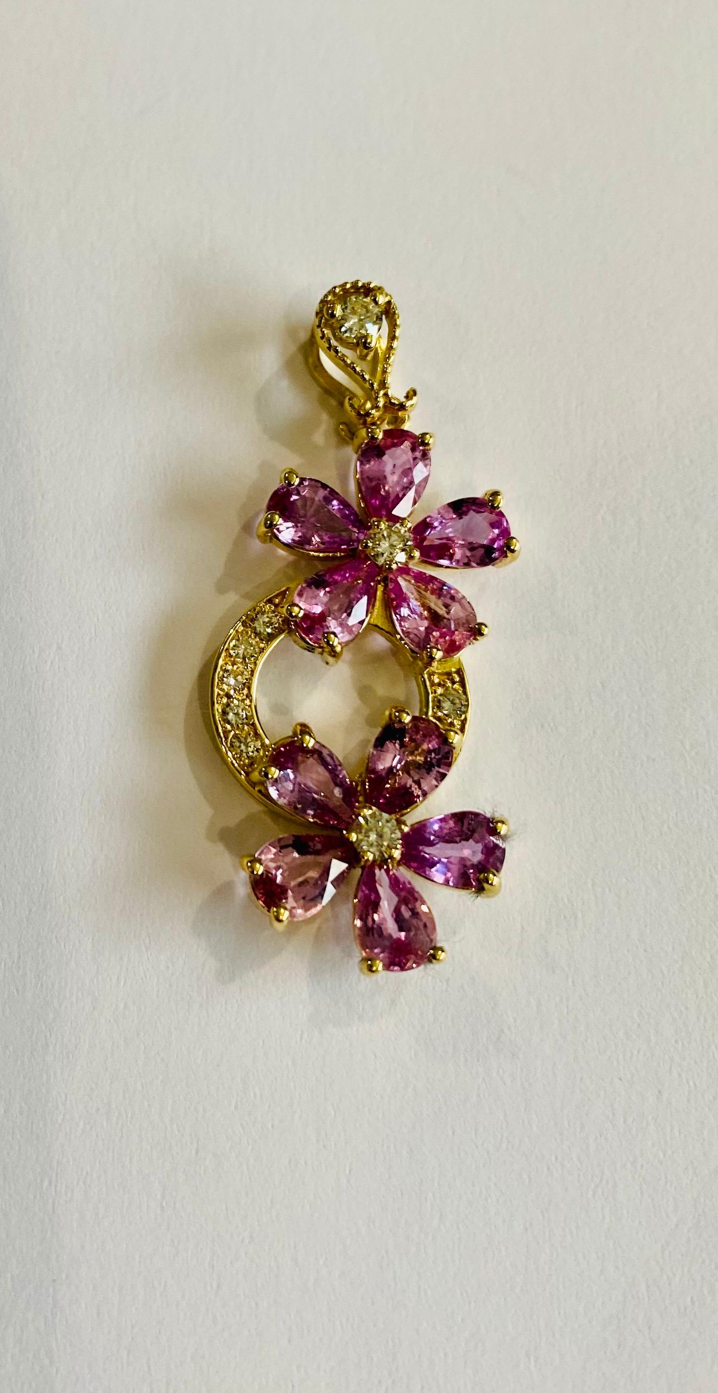 Simply Gorgeous Sapphire Pendant with beautiful hues of Pink and a hint of Purple. 

This beauty will pair wonderfully for any occasion! Even as a daily and classy addition to your collection. 

There are 10 Natural Pear Cut Sapphires that weigh a