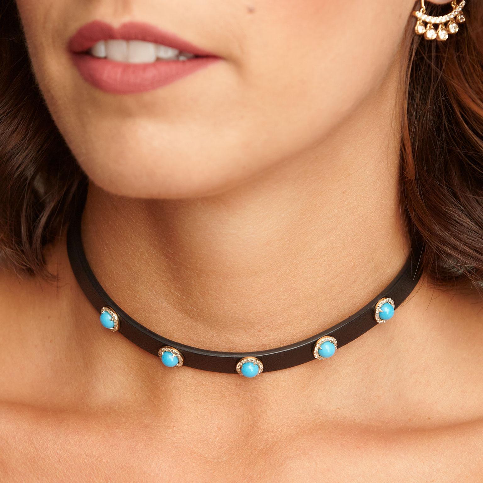 4.31 Carat Turquoise and Diamond Black Leather Choker Necklace

0.16 carat of pave set diamond set in 14 karat yellow gold surround 6 millimeter turquoise cabochon with a total weight of 4.31 carat. 
Affixed to black leather, this choker necklace is