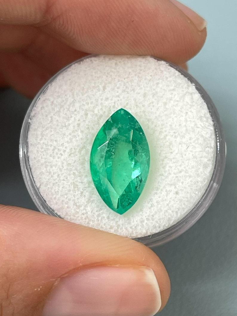 Stone: Emerald
Weight: 4.31-carats
Shape: Marquise Cut
Clarity: Transparent
Luster: Very Good
Color: Medium Bluish Green
Measurements: 14.87mm x 8.58mm x 6.43mm
Geographic Origin: Colombia
Treatment: Natural, Oiling

Comments: Due to their growth