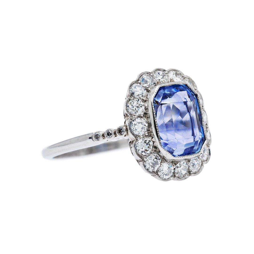  Featuring a 4.32 carat sapphire that exudes the sought after cornflower blue from the Ceylon region. Surrounded by 16 old European cut diamonds that are F-G color, VS clarity weighing approximately 0.80 carats total. Hand crafted in platinum.  