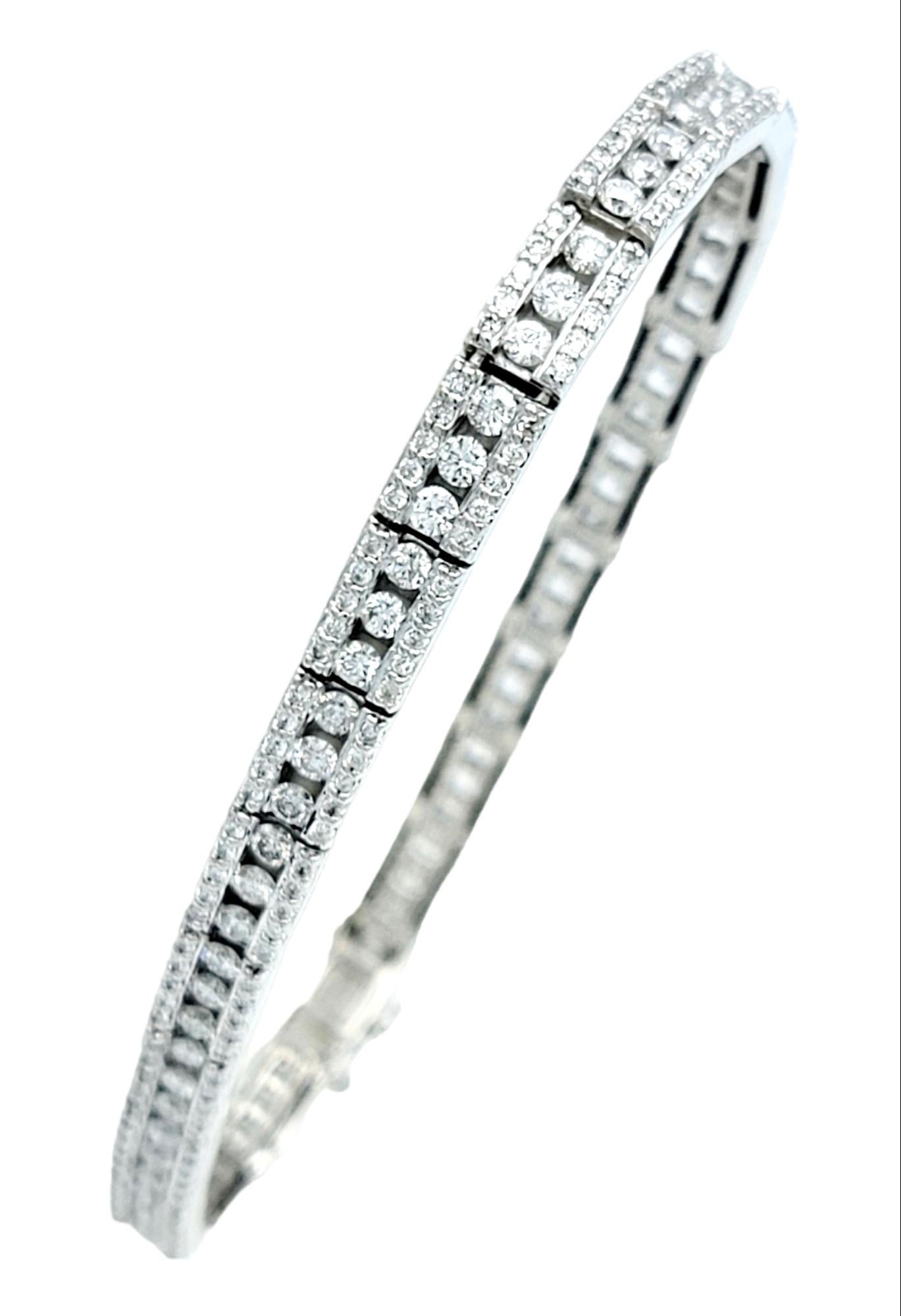 Introducing an exquisite three-row diamond tennis bracelet in elegant 14 karat white gold. This dazzling piece combines timeless sophistication with a touch of modern allure.

At the heart of each link rests three brilliant round diamonds, their