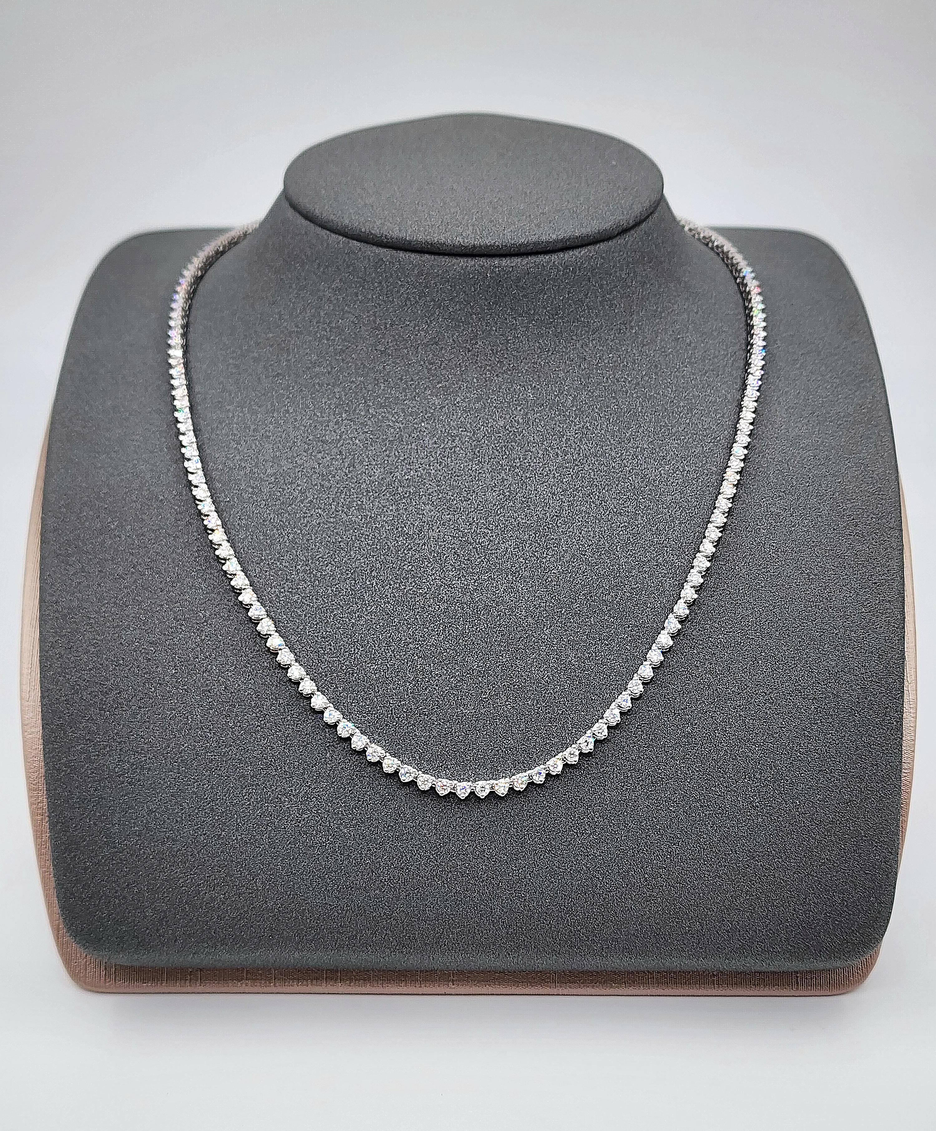 This exquisite tennis necklace showcases round diamonds with a total carat weight of 4.32. The diamonds are F/G in color and VS2/SI1 in clarity. Crafted in 14k white gold, the necklace measures 17 inches in length. Made in the USA, this modern piece