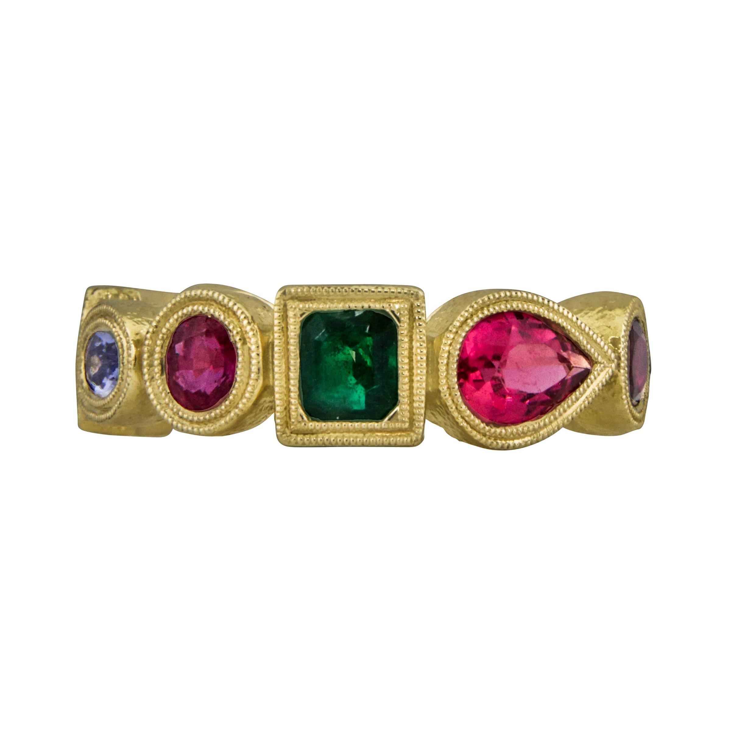 Featured is a hand crafted 18 karat yellow gold ring with 10 semi precious gemstones weighing 8.00 grams finished with a lightly brushed texture size 7.00 USA
Featured stones

1 square emerald 
1 round ruby 
1 oval iolite 
1 square ruby 
1 round