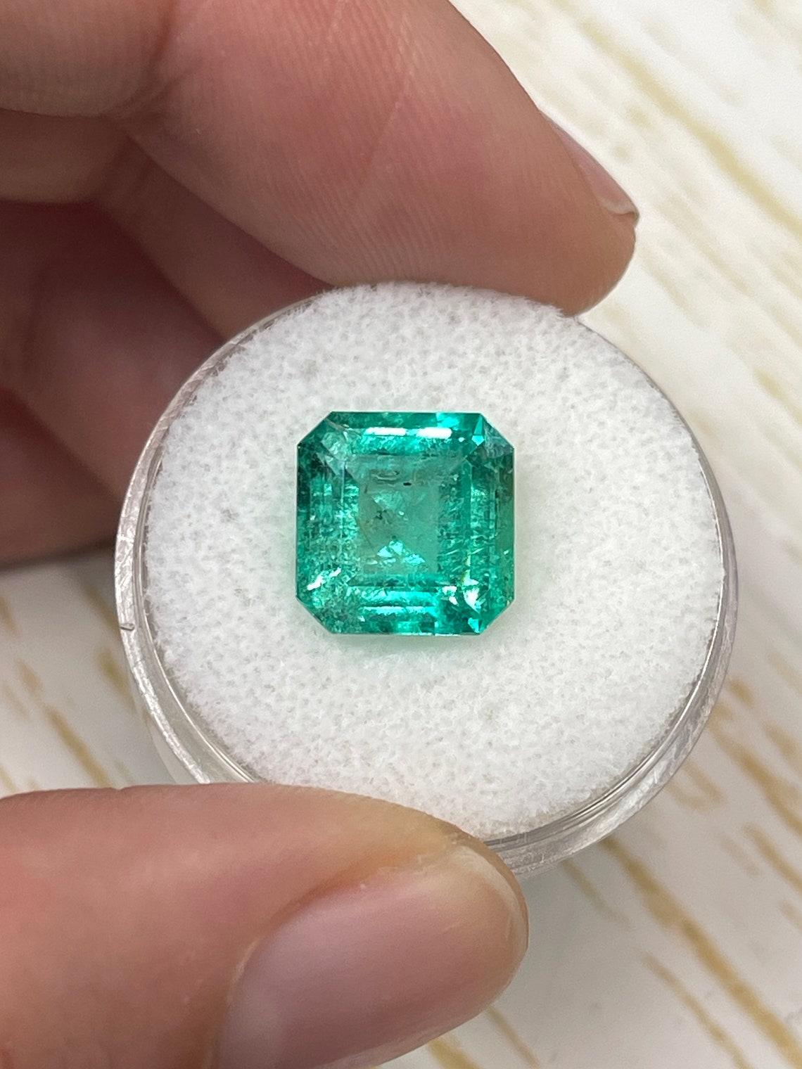 Stone: Emerald
Weight: 4.33-carats
Shape: Asscher Cut
Clarity: Transparent
Luster: Very Good
Color: Bluish Green
Measurements: 10.32mm x 10.10mm x 6.22mm
Geographic Origin: Colombia
Treatment: Natural, Oiling

Comments: Due to their growth