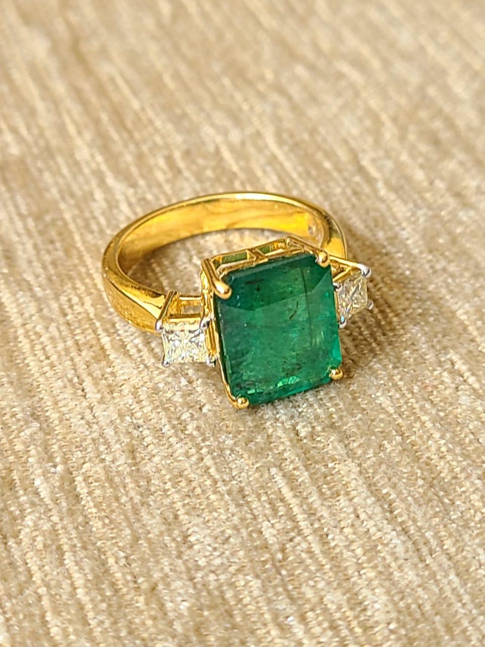 A very wearable and simple Emerald and Diamonds ring set in 18K Yellow Gold. The Emerald, is of Zambian origin, weighs 4.34 carats. The Emerald is completely natural, without any treatment. The weight of the diamonds is 0.45 carats. The net Gold