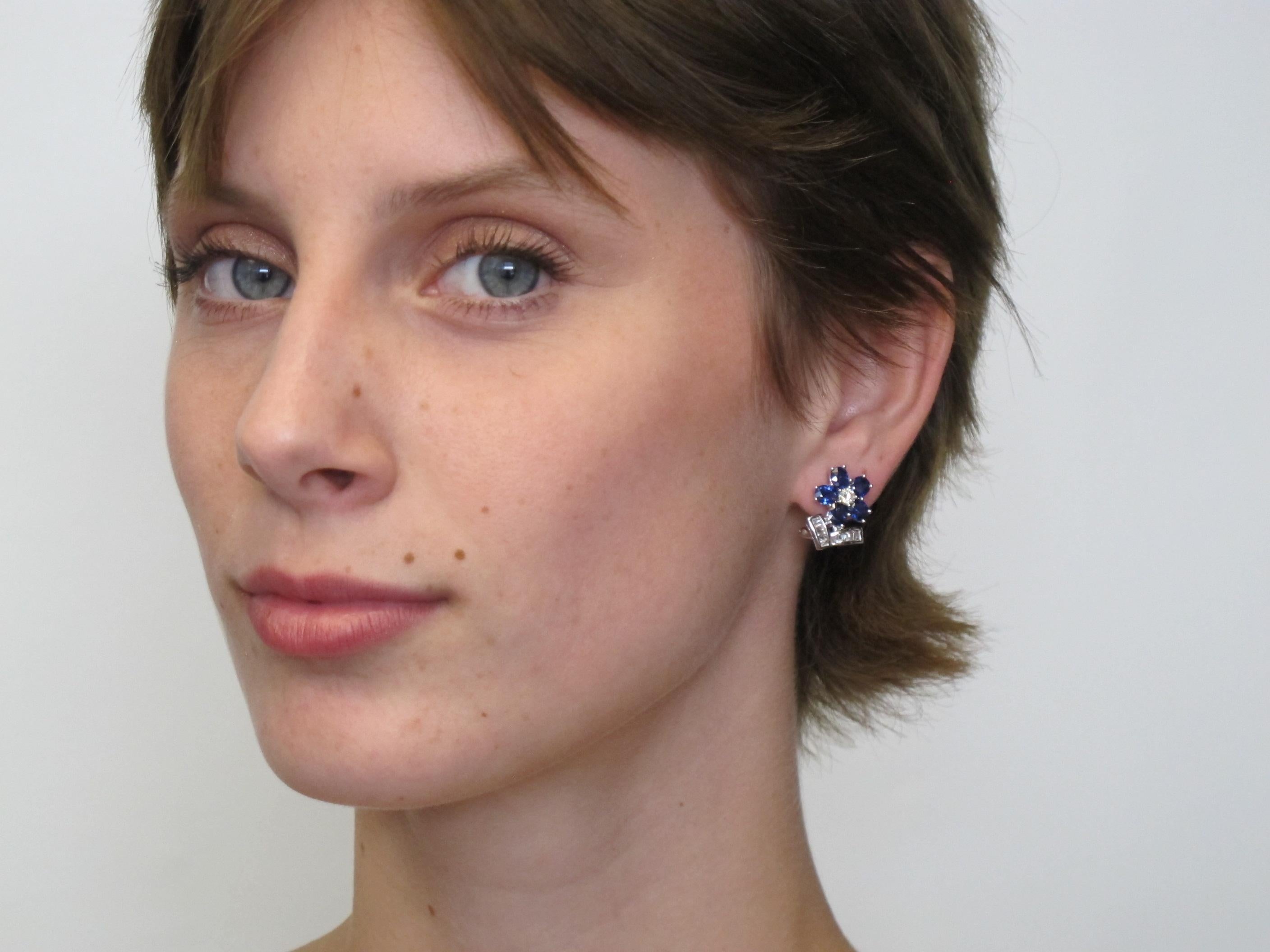 These beautiful earrings feature 10 oval blue sapphires (4.35cts/tw) with 2 round brilliant diamonds (0.32cts/tw) and 24  baguette cut diamonds (0.31cts/tw). They are pierced French clips, so they lay beautifully on the ear and nestle the cheek