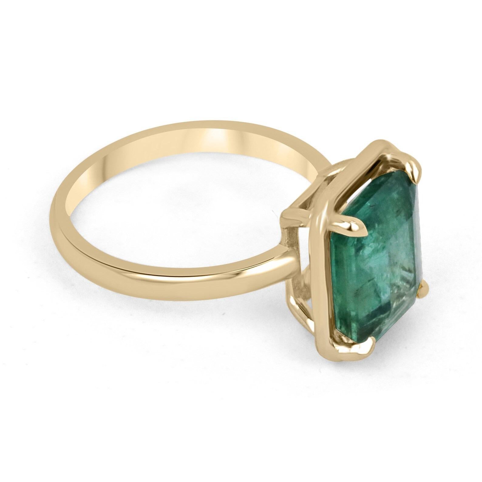 Displayed is a classic emerald solitaire engagement or right-hand ring. This spectacular piece features a remarkable 4.35-carat, natural emerald cut emerald from the origins of Zambia. The center stone showcases a mossy medium-green color that