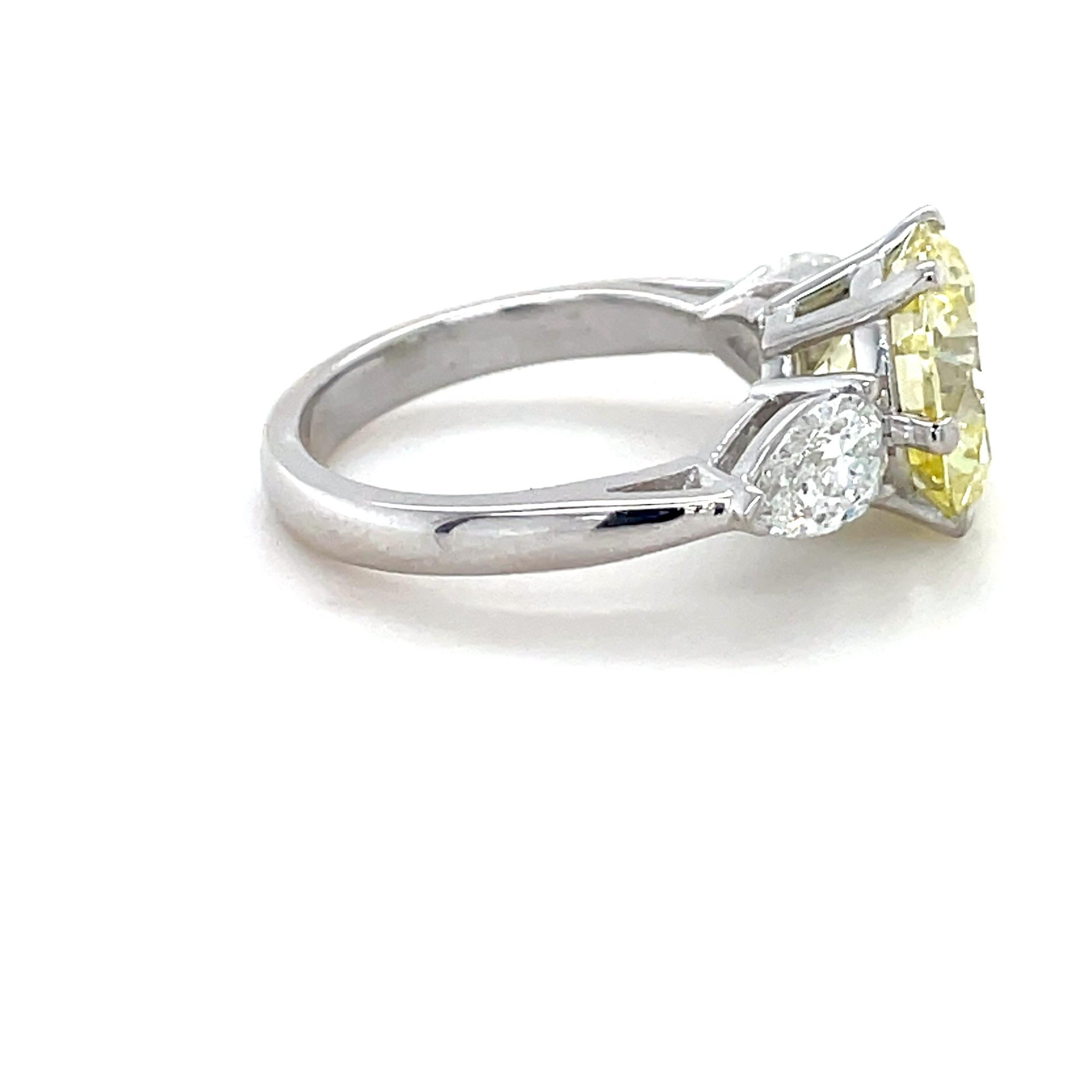 Brilliant Cut 4.35 Carat Natural Fancy Yellow Diamond and Diamond Ring For Sale