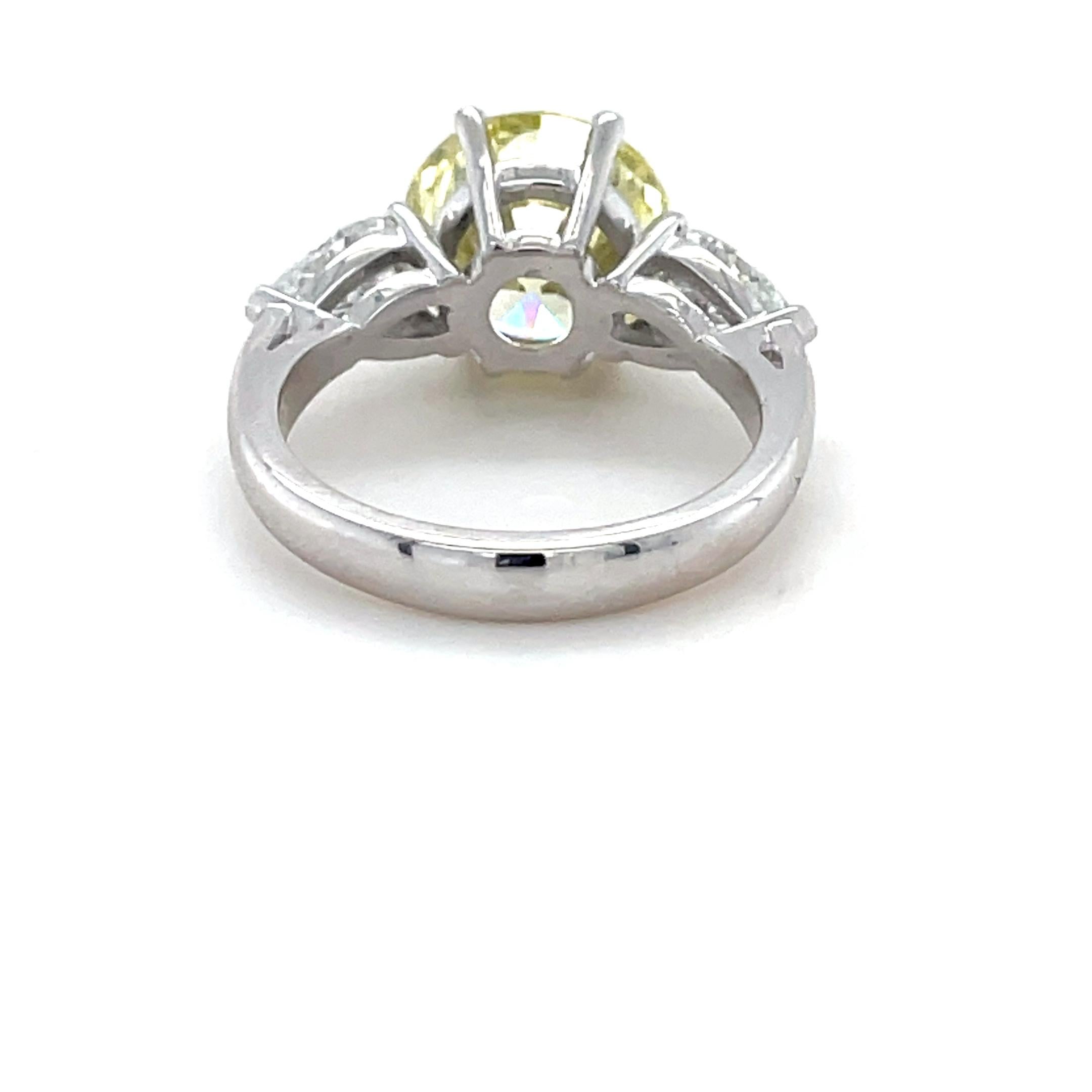 4.35 Carat Natural Fancy Yellow Diamond and Diamond Ring In Excellent Condition For Sale In Chicago, IL