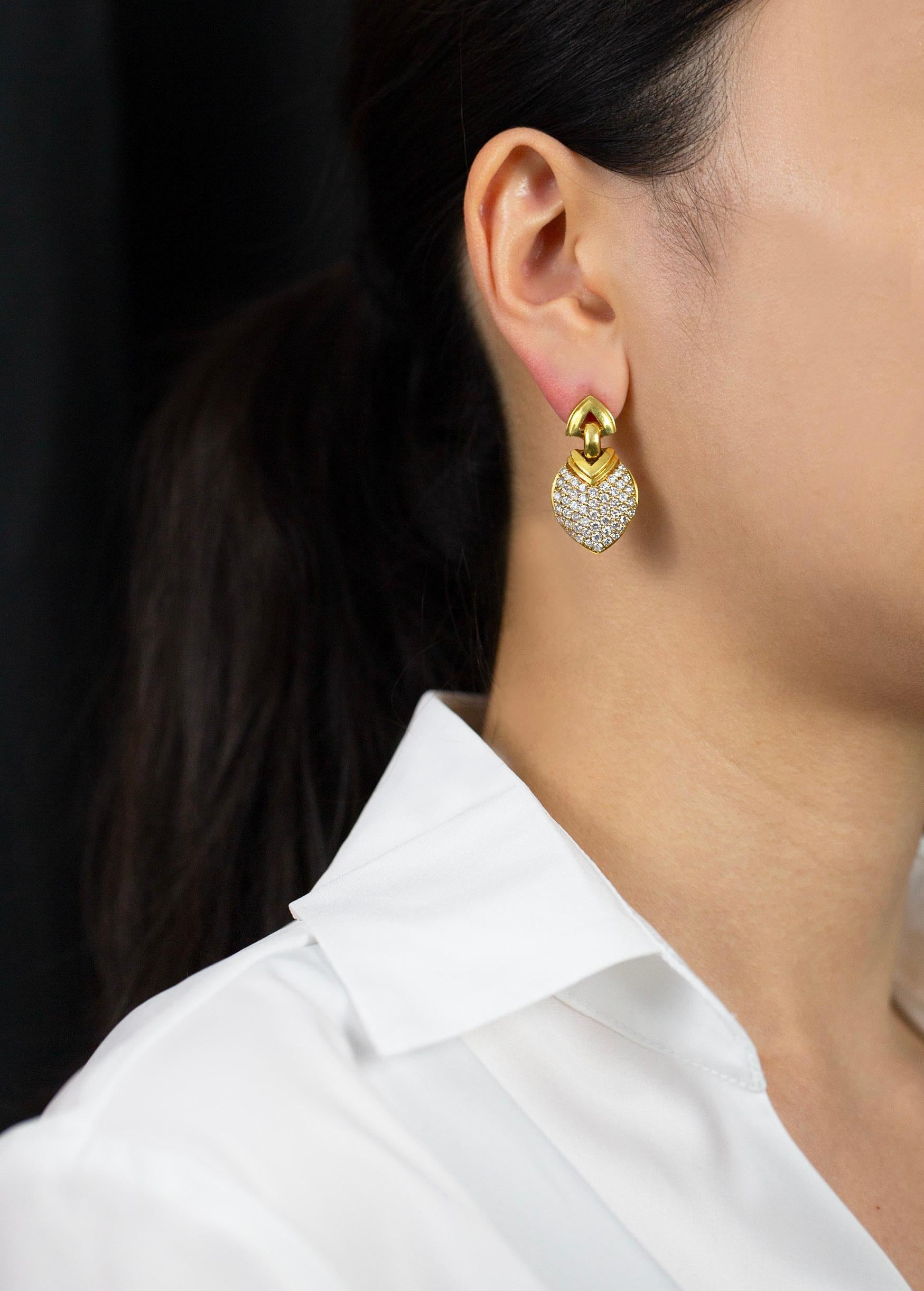 A modern looking pair of clip-on hanging earrings consisting of geometric shape encrusted with brilliant round diamonds. Diamonds weigh 4.35 carats total. Made in 18K Yellow Gold. Omega-clip with post.

Roman Malakov is a custom house, specializing