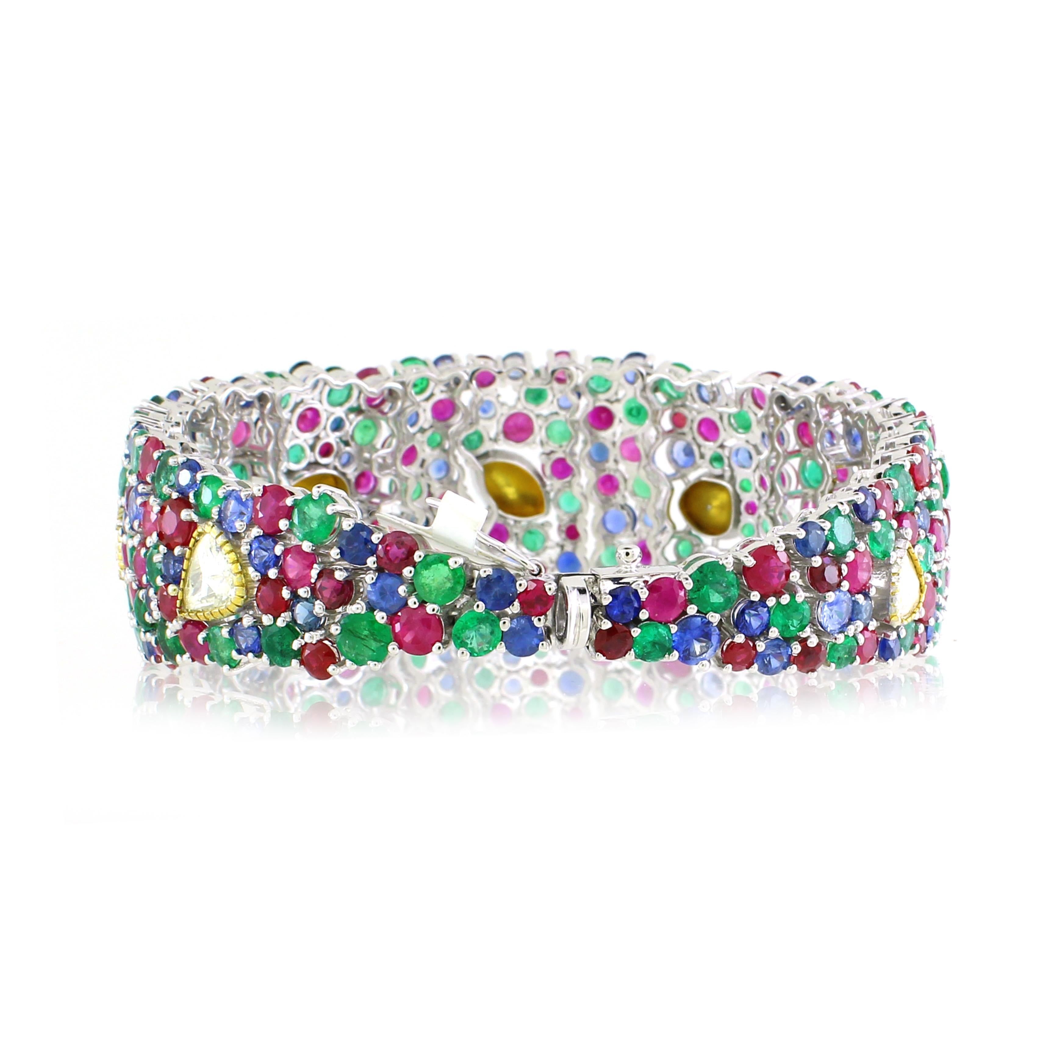 This exquisite multicolored bracelet is a testament to fine craftsmanship and timeless elegance. It features an enchanting combination of 87 round emeralds totaling 13.61 carats, 99 round rubies weighing 19.41 carats, and 82 round sapphires
