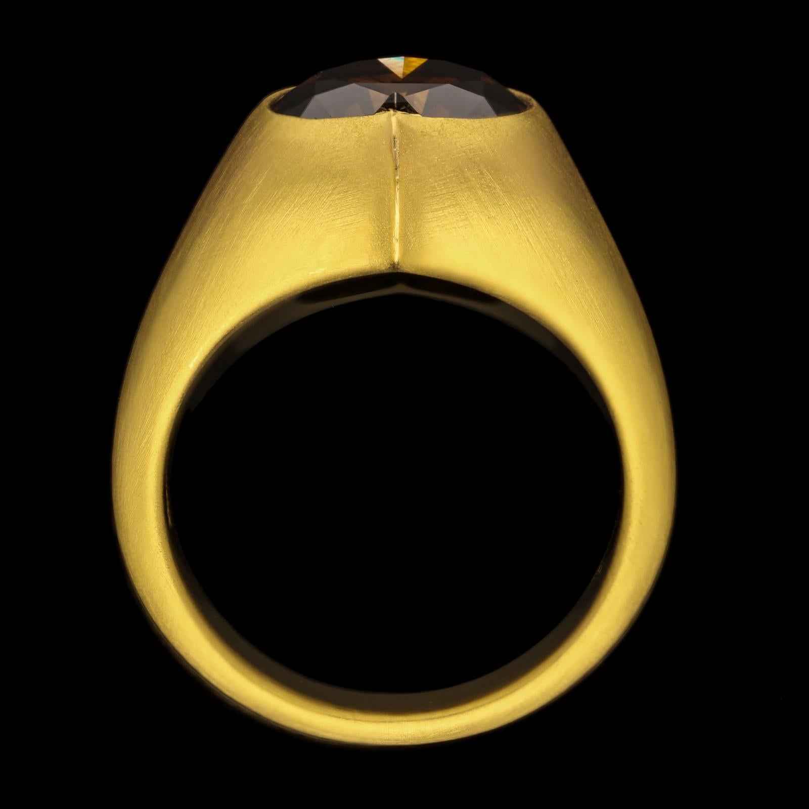 A striking and contemporary rare fancy coloured diamond gypsy ring by Hancocks, set with a richly coloured fancy dark orangy brown heart shaped brilliant cut diamond weighing 4.39cts rub-over set in a finely hand crafted 22ct yellow gold ring with a