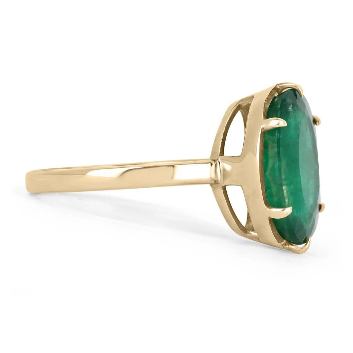 Displayed is a custom emerald solitaire oval-cut engagement/right-hand ring in 14K yellow gold. This gorgeous solitaire ring carries a 4.39-carat emerald in a prong setting. The emerald has very good clarity with minor flaws that are normal in all
