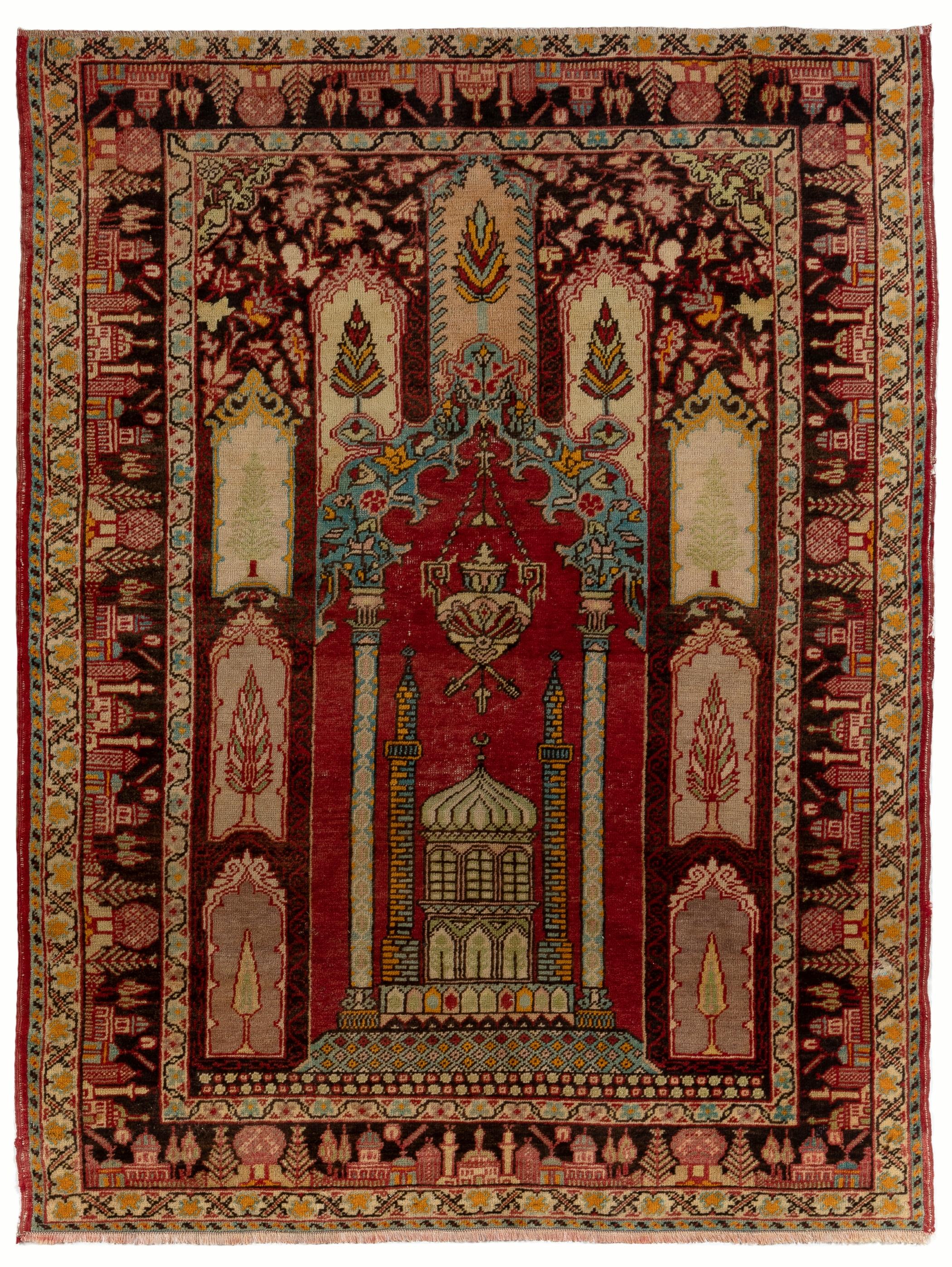 A one-of-a-kind semi antique Anatolian prayer rug featuring a carefully constructed arch design, framing at its base the depiction of a mosque that stands under a large pendant lamp and between two grand columns reaching into the ornate crown of the