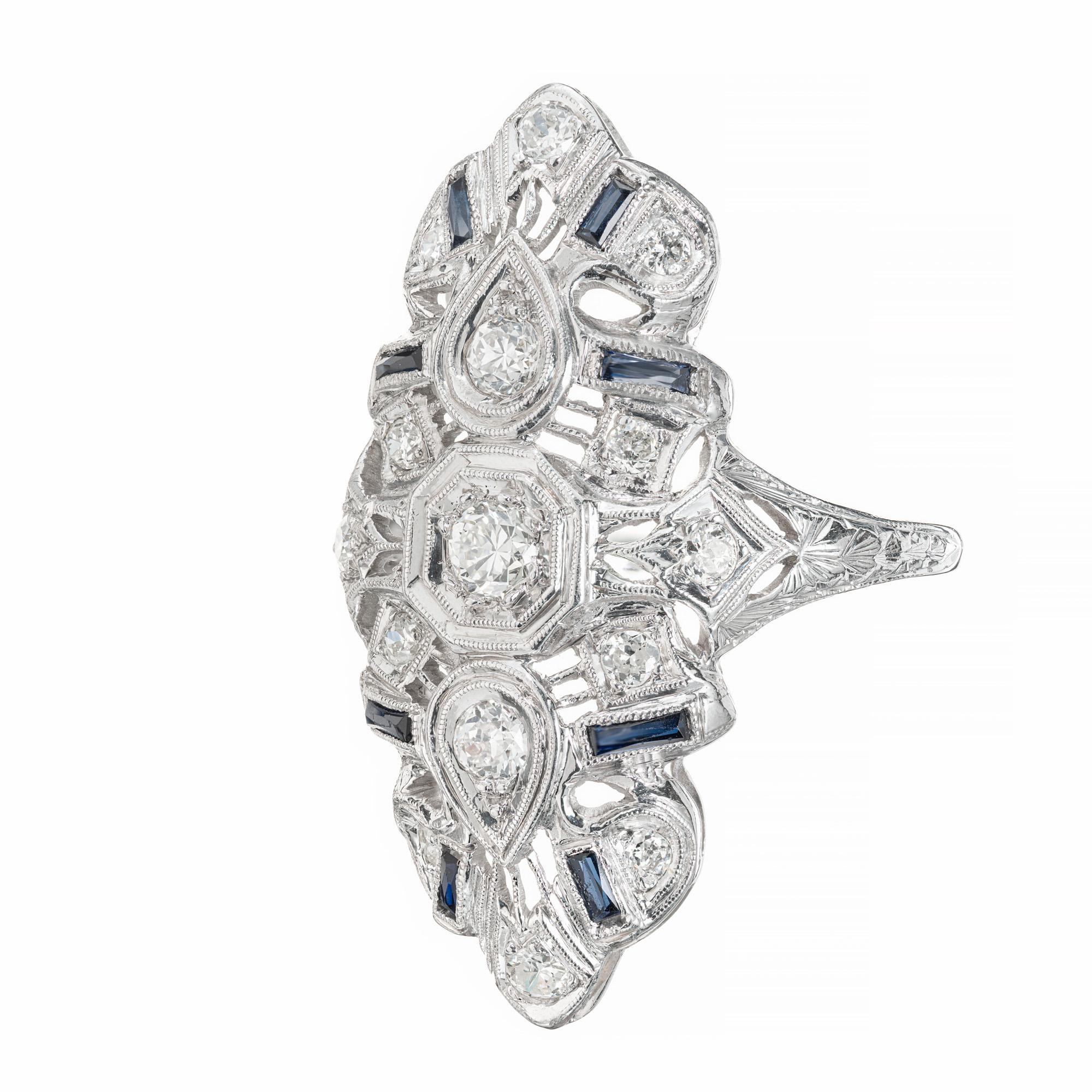 Classic late art deco open work 1930's cocktail ring. 15 round diamonds in a platinum setting accented with 8 French cut baguette sapphires in a platinum setting. 

15 round diamonds, h-I VS SI approx. .44cts
8 French cut blue baguette sapphires,