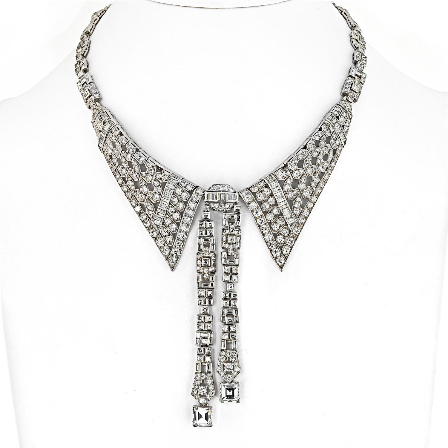 This beautiful timeless elegance of this estate platinum necklace is reminiscent of a sophisticated shirt collar. This exquisite Art Deco piece features a lavalier design adorned with a captivating array of mixed-cut diamonds. The meticulous