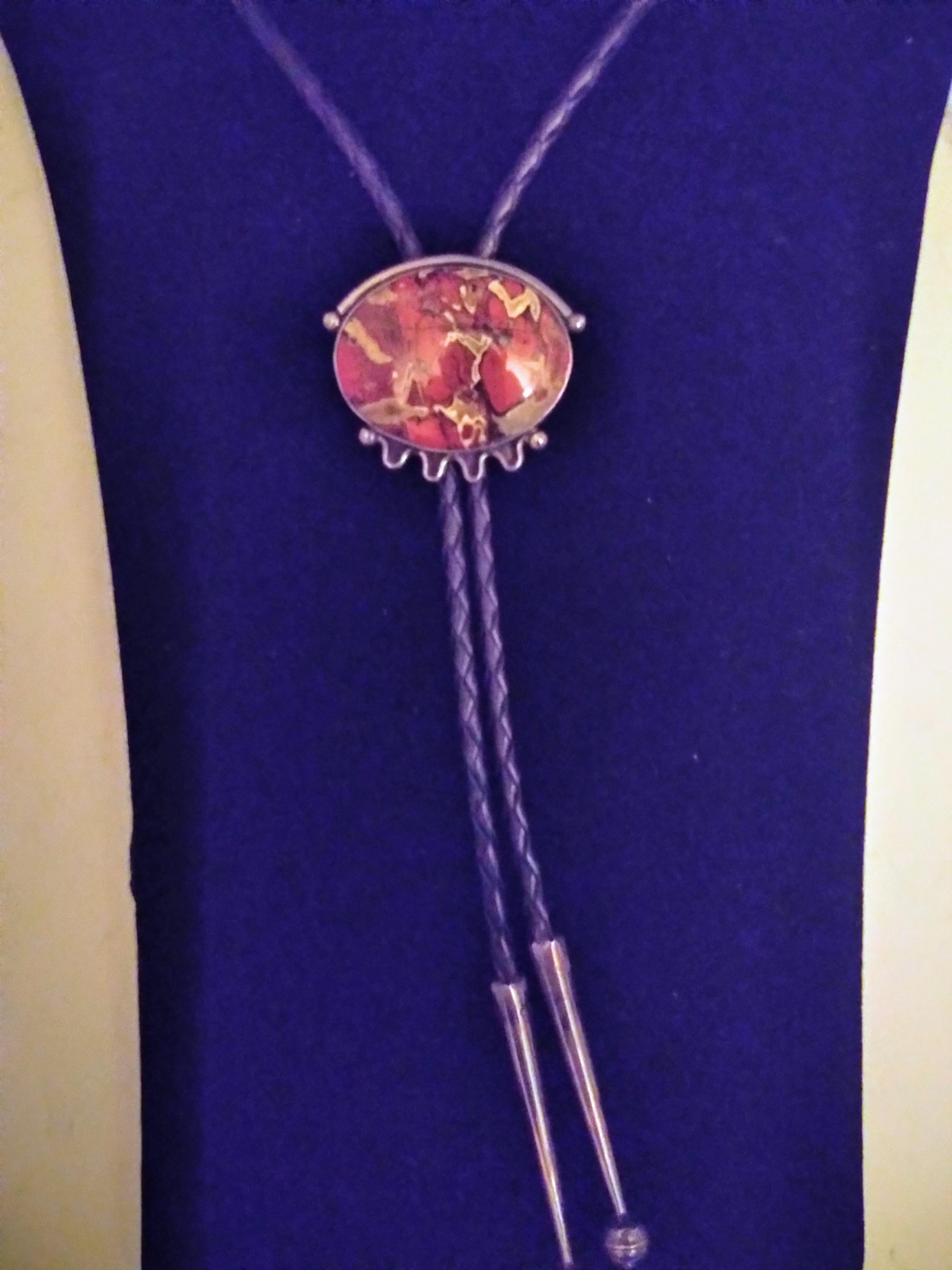 This is a beautiful bolo tie. It's made of braided leather and sterling silver and has a beautiful piece of marbled agate as the setting of the medallion..The tips are crafted in silver also.

Great for a night out on the town.


Ready to wear.