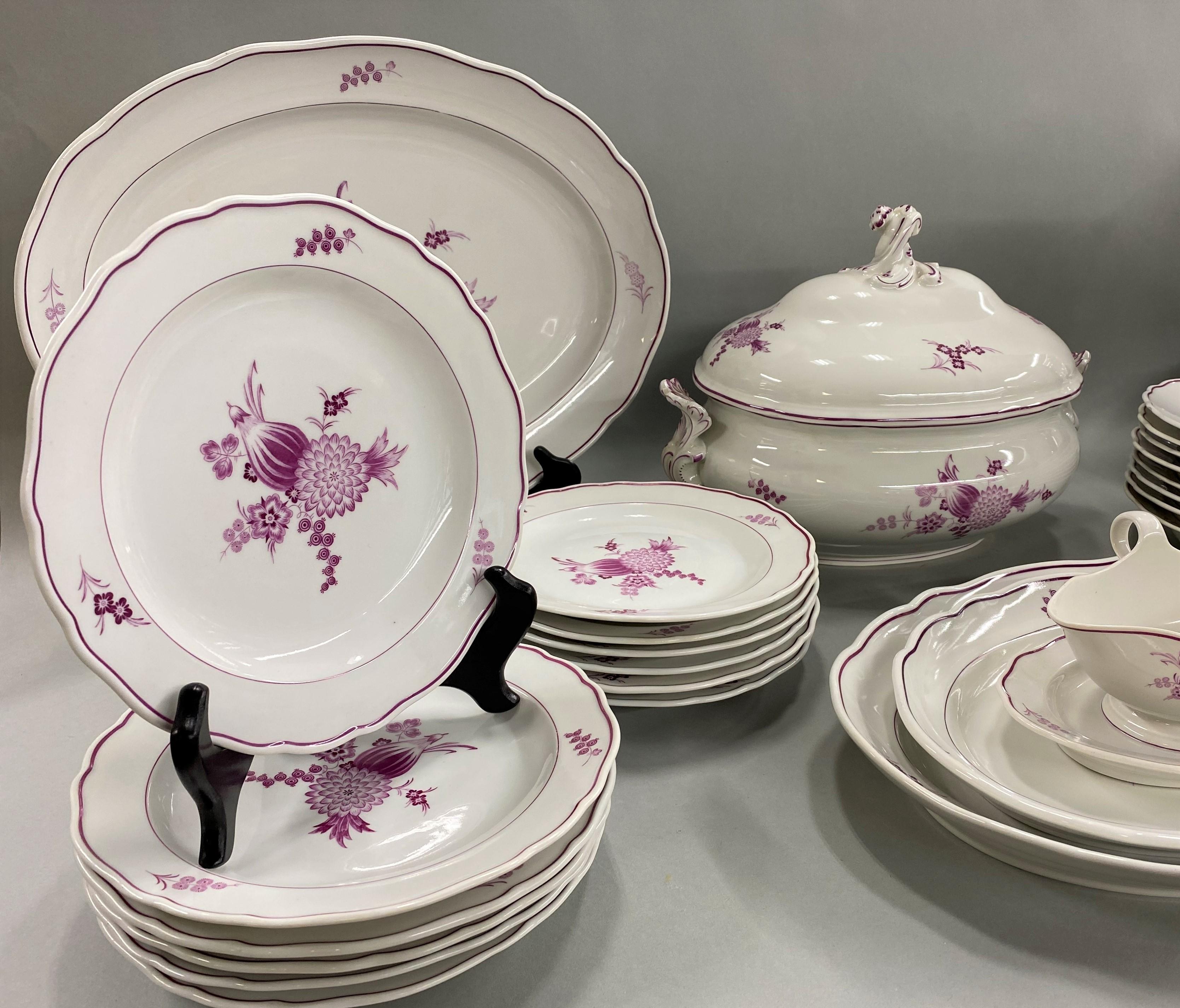 A fine 49-piece Meissen porcelain dinner service in a rare purple/puce color, including 10 10-inch dinner plates, 12 9-inch luncheon plates, 12 6.25-inch bread plates, 9 soup bowls (2 inch height x 9.5-inch diameter), 1 oval serving dish (14-inch x
