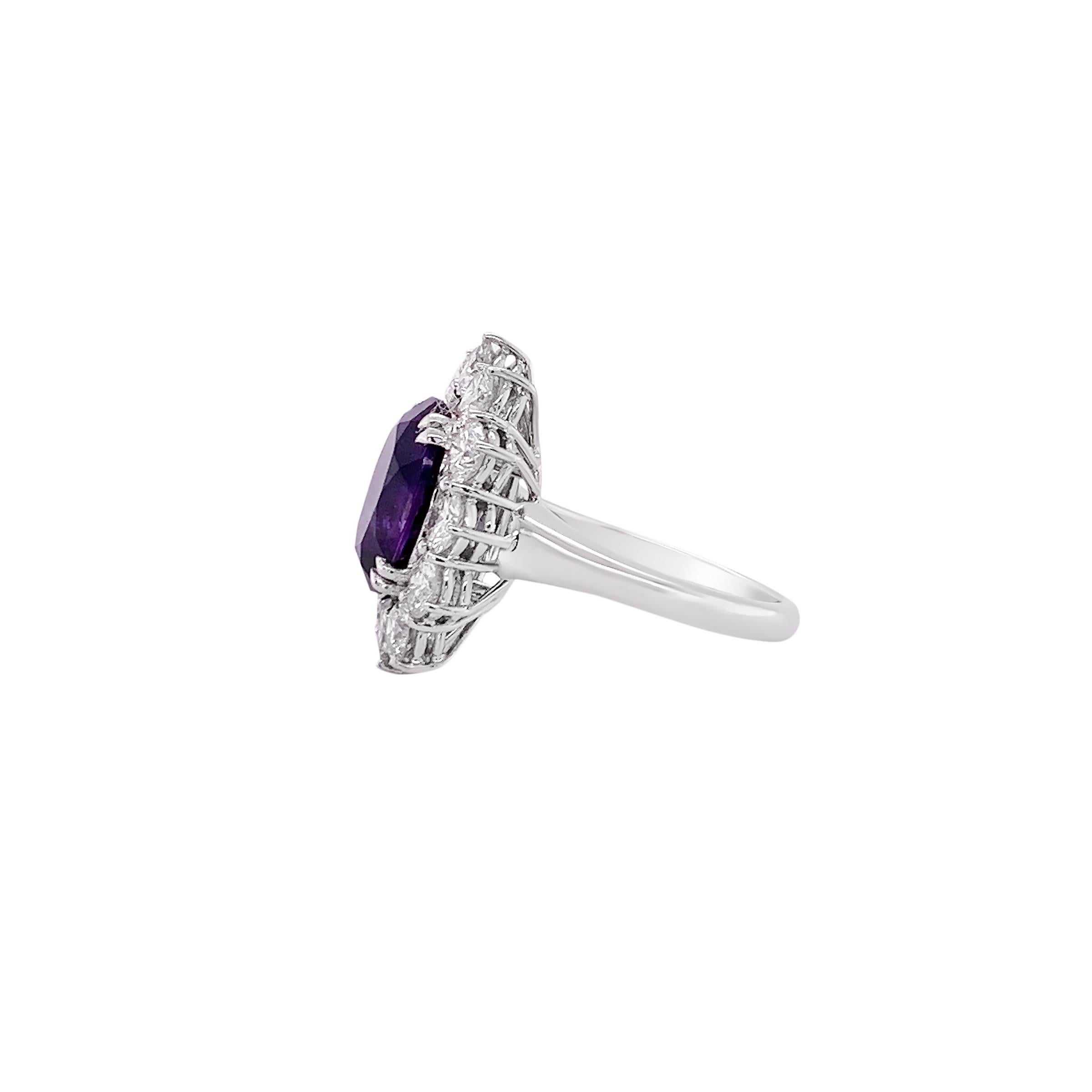 This ring features a magnificent vivid 4.40 carat amethyst at its center. This deep purple gemstone is encircled by a halo of meticulously selected natural diamonds totaling 3 carats. Each diamond has been hand selected for vvs quality to complement