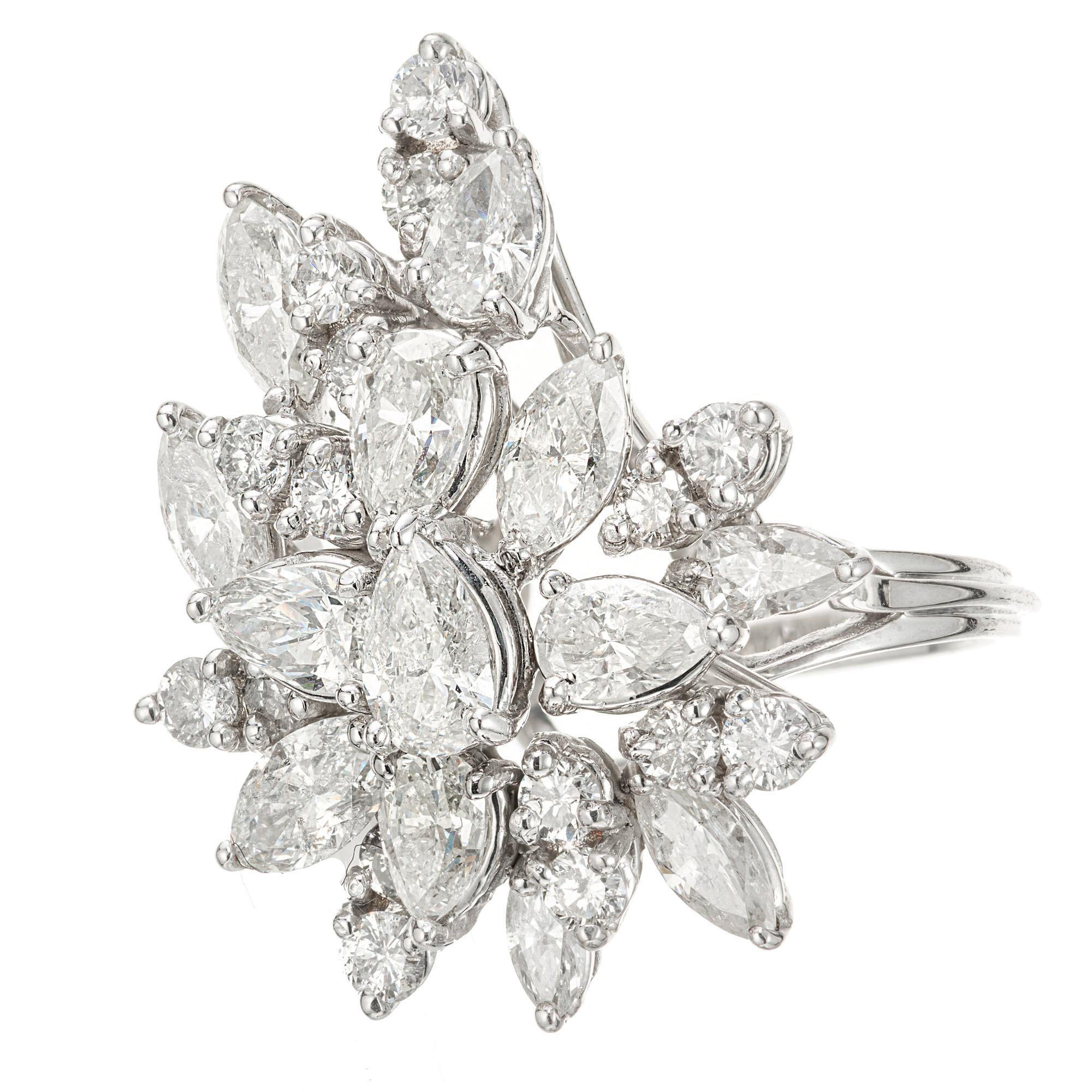 1950's classic example of a diamond cluster cocktail ring. 7 pear shaped, 6 Marquise shaped and 16 round shaped diamonds set in a platinum cocktail ring setting. 

7 pear shape diamonds, I-J-K I approx. 2.10cts
6 marquise diamonds, I-J-K I approx.
