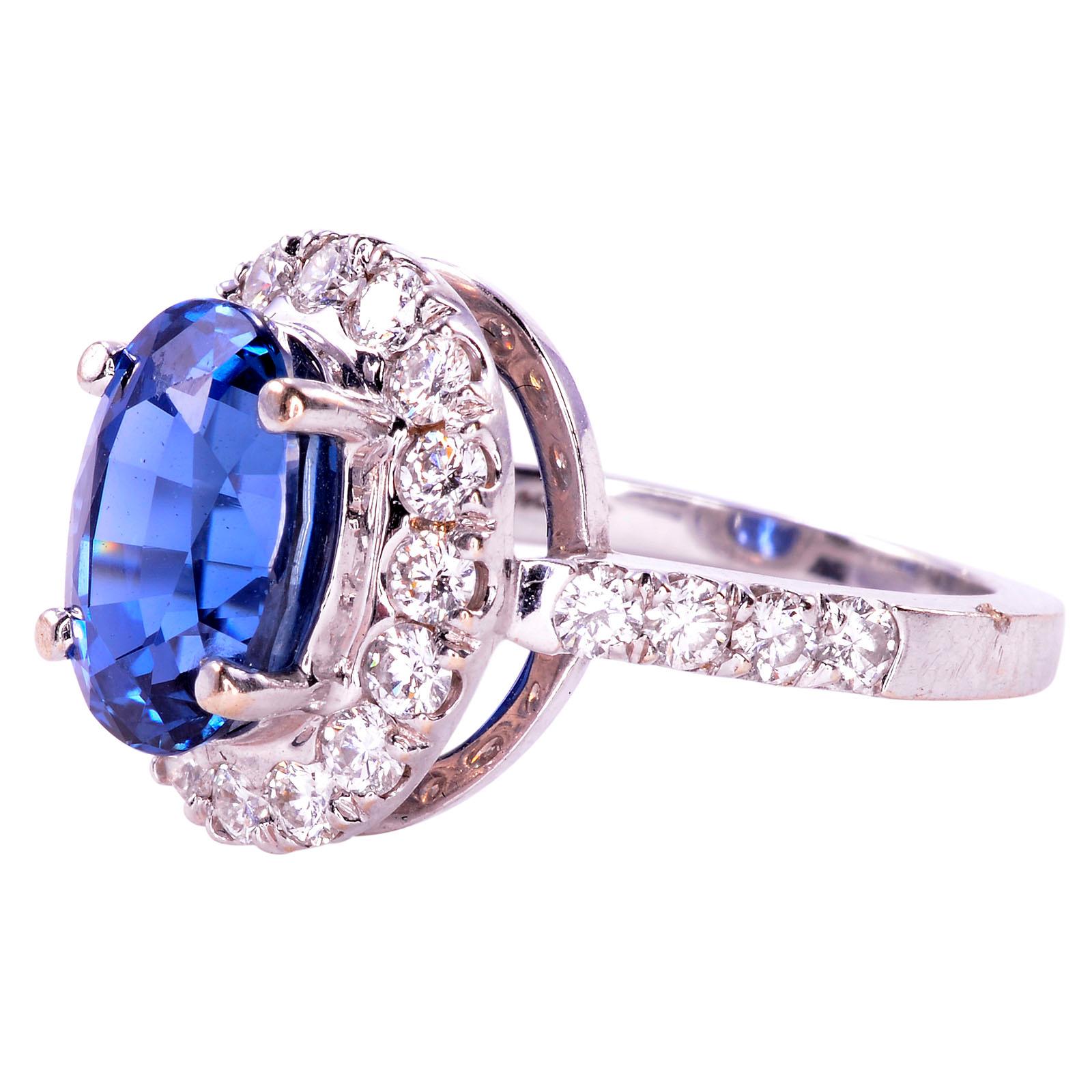 Estate 4.40 carat GIA certified natural untreated sapphire and diamond ring. This 18 karat white gold ring has one GIA certified natural (non heat treated) sapphire at 4.40 carats. This estate sapphire ring is accented with 24 round brilliant