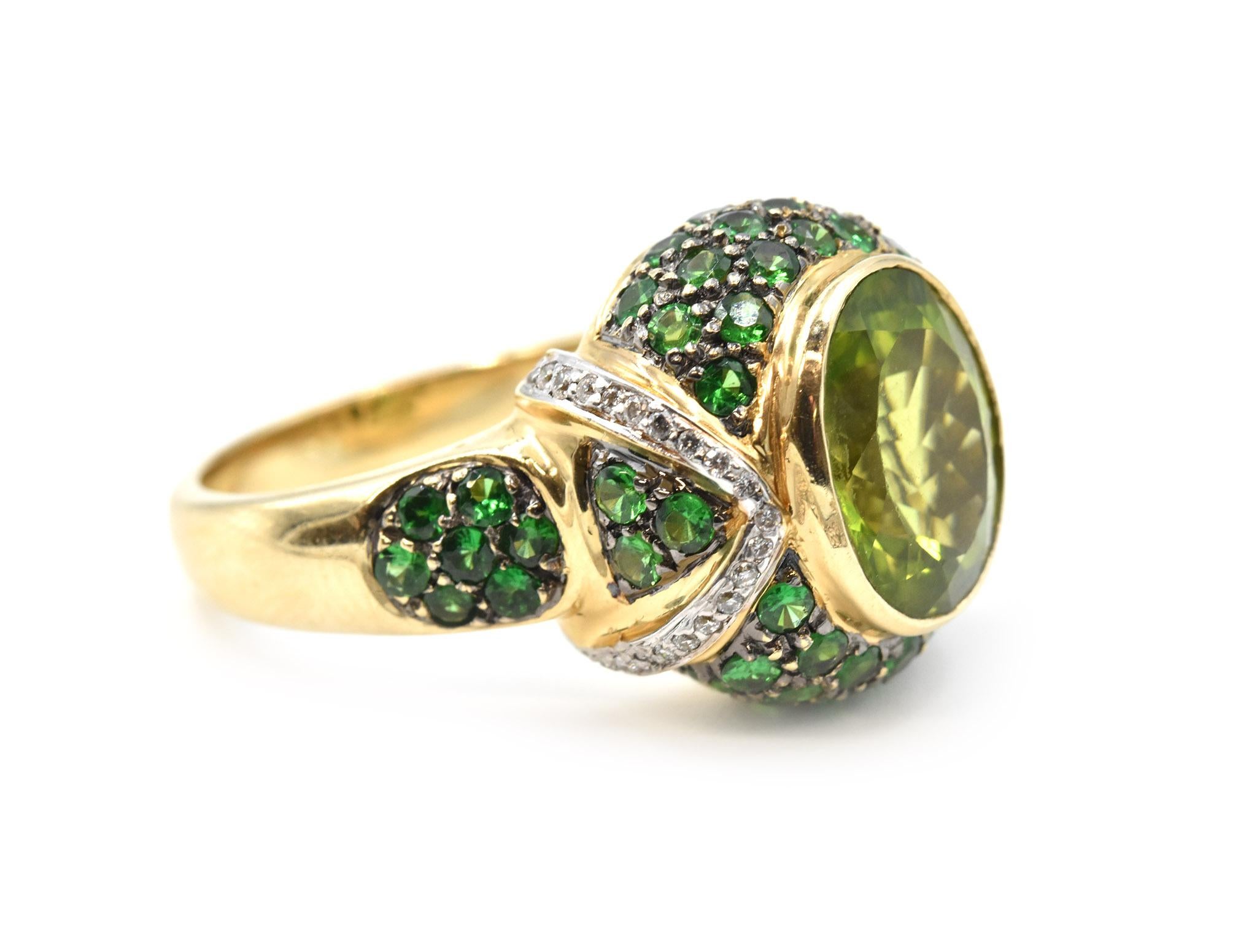 Designer: custom design
Material: 14k yellow gold 
Peridot: 4.40 carat oval peridot
Tsavorites: 3.25 carat weight
Diamonds: 40 round brilliant cut = 0.30 carat weight 
Ring Size: 7 (please allow two additional shipping days for sizing requests)