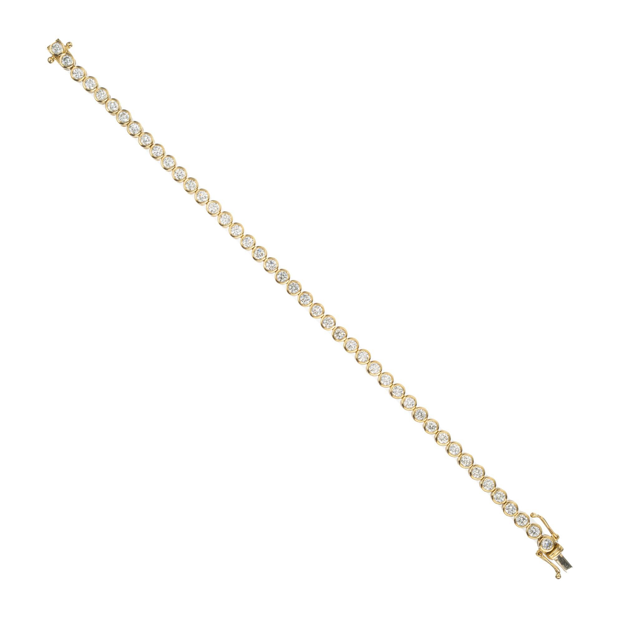Radiate elegance and sophistication with this exquisite 4.40ct round diamond bezel yellow gold tennis bracelet. Crafted to perfection, this 7 inch bracelet features 44 stunning round bezel set diamonds in 18k yellow gold which creates a dazzling and
