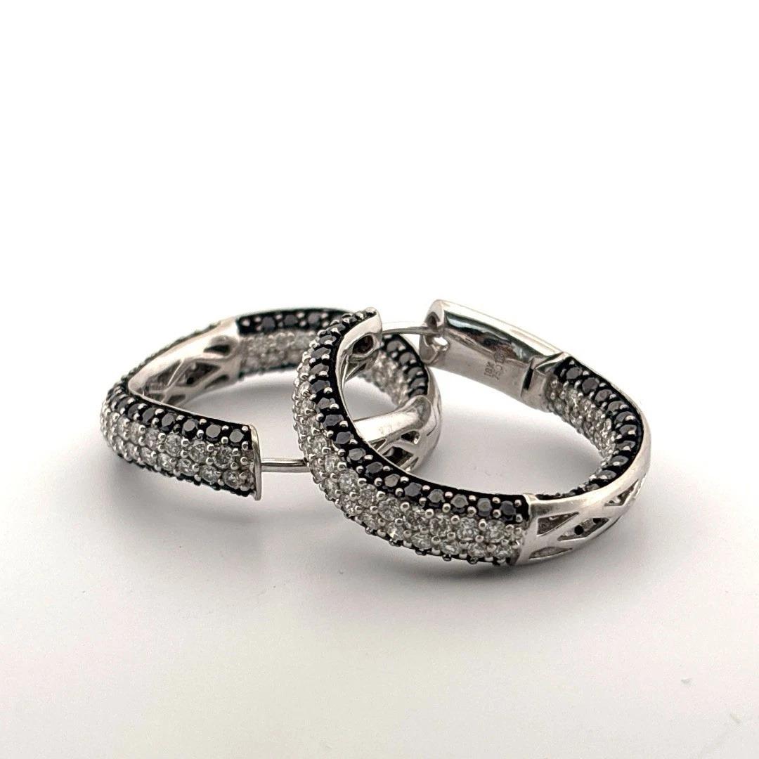 🡆 Offered is a luxurious and eye-catching pair of 18K white gold inside-outside hoop earrings. These hinged oval hoops are fully stamped 750 (18K) and weigh a substantial 17.45 grams for the pair. They feature a bold combination of black and white