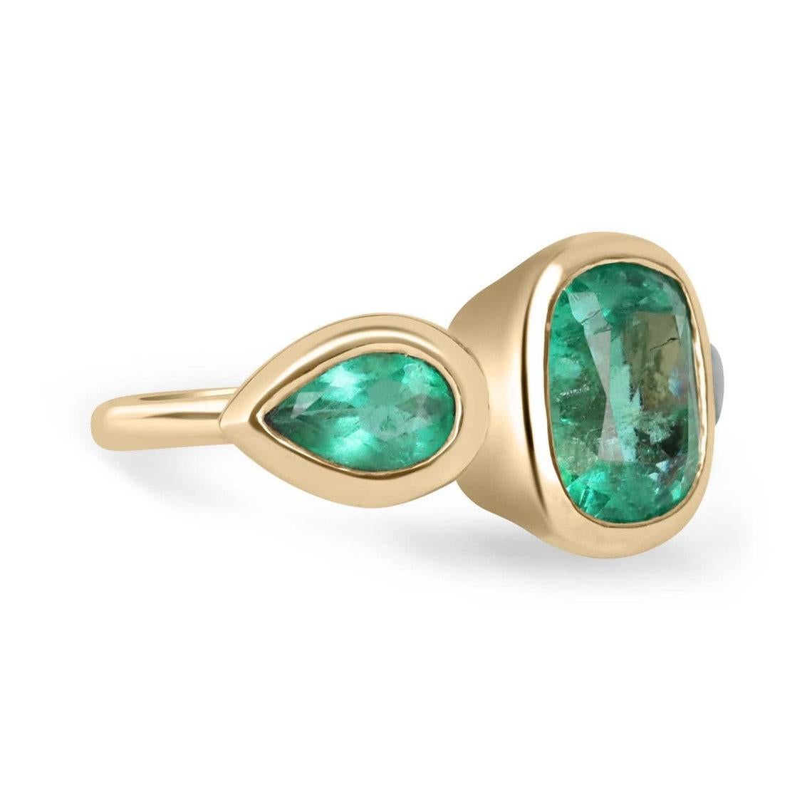 Werfen Sie einen Blick auf diesen atemberaubenden Ring mit drei Smaragden und Steinen. Der Mittelstein ist ein wunderschöner kolumbianischer Smaragd von 2,90 Karat in Form eines Kissens. Dieser Hauptstein wird auf beiden Seiten von Smaragden im
