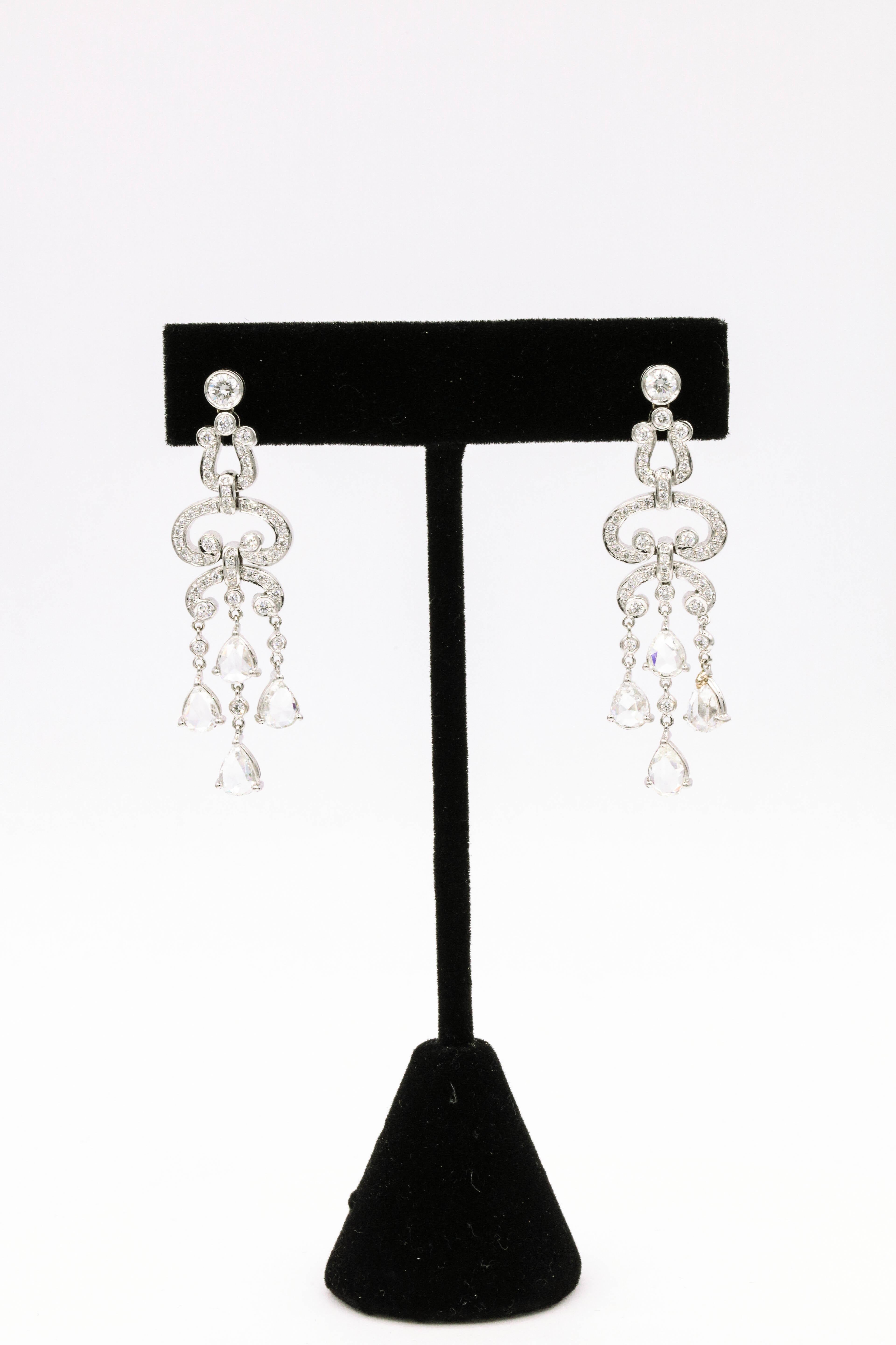 Art Deco style drop earrings featuring 108 round brilliants, 1.21 carats and 8 pear shape diamonds weighing 3.20 carats, in 14k white gold. 
Color: G-H
Clarity: VS-SI