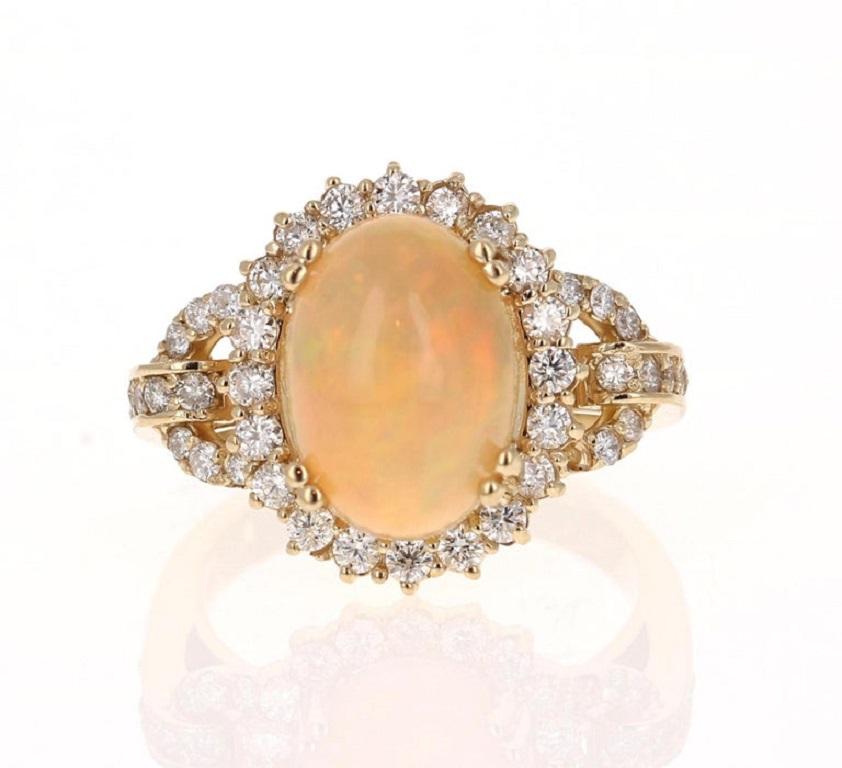 This beautiful and classic piece has a 3.59 Carat Oval Cut Opal and is surrounded by 46 Round Cut Diamonds that weigh 0.82 Carats (Clarity: SI2, Color: F).
The Total Carat Weight of the ring is 4.41 Carats.

The ring is made in 14K Yellow Gold and