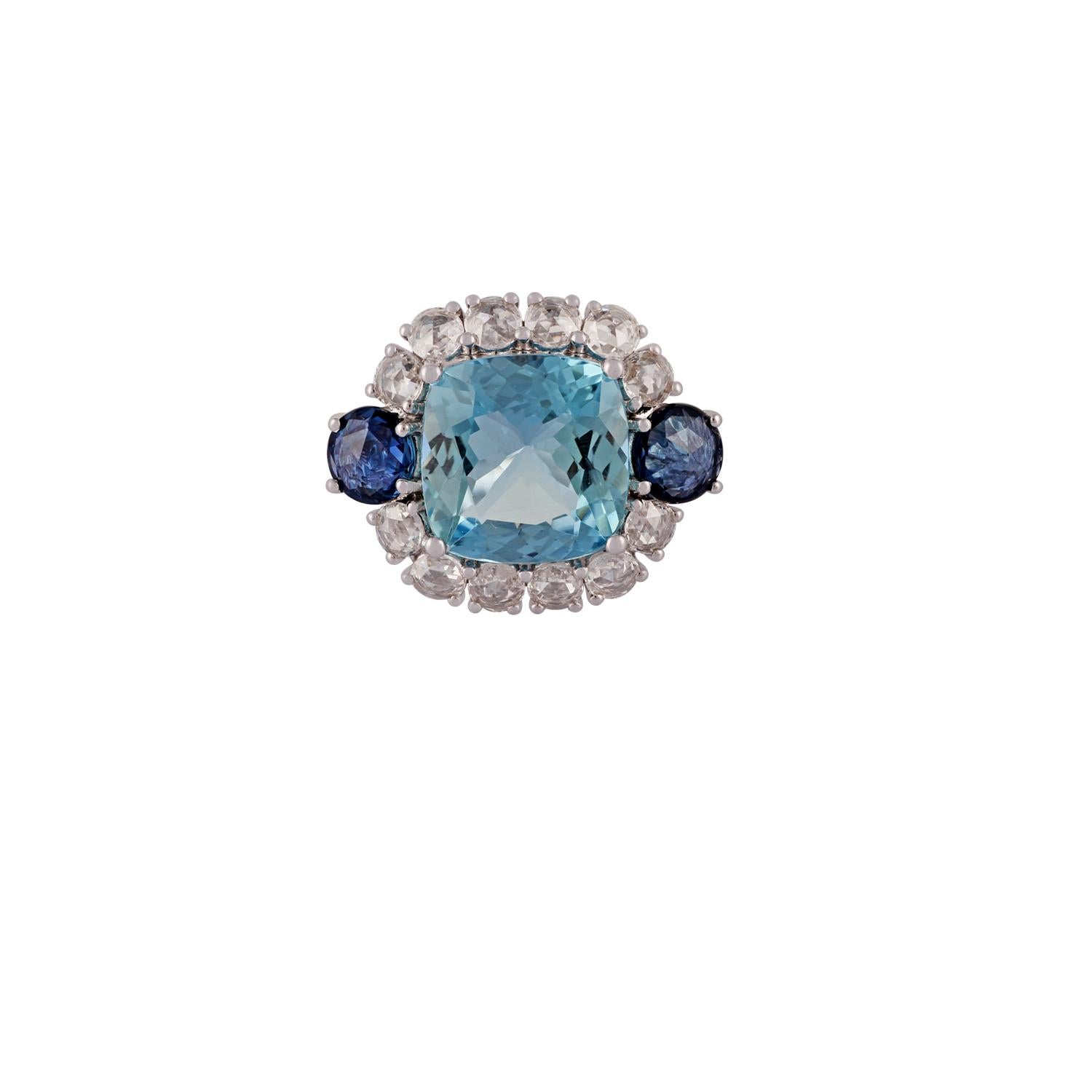 This is an exclusive aquamarine, blue sapphire & diamond ring studded in 18k white gold features 1 piece of cushion shaped aquamarine weight 4.42 carats with 2 pieces of round shaped rose cut blue sapphires on two sides weight 1.16 carats &
